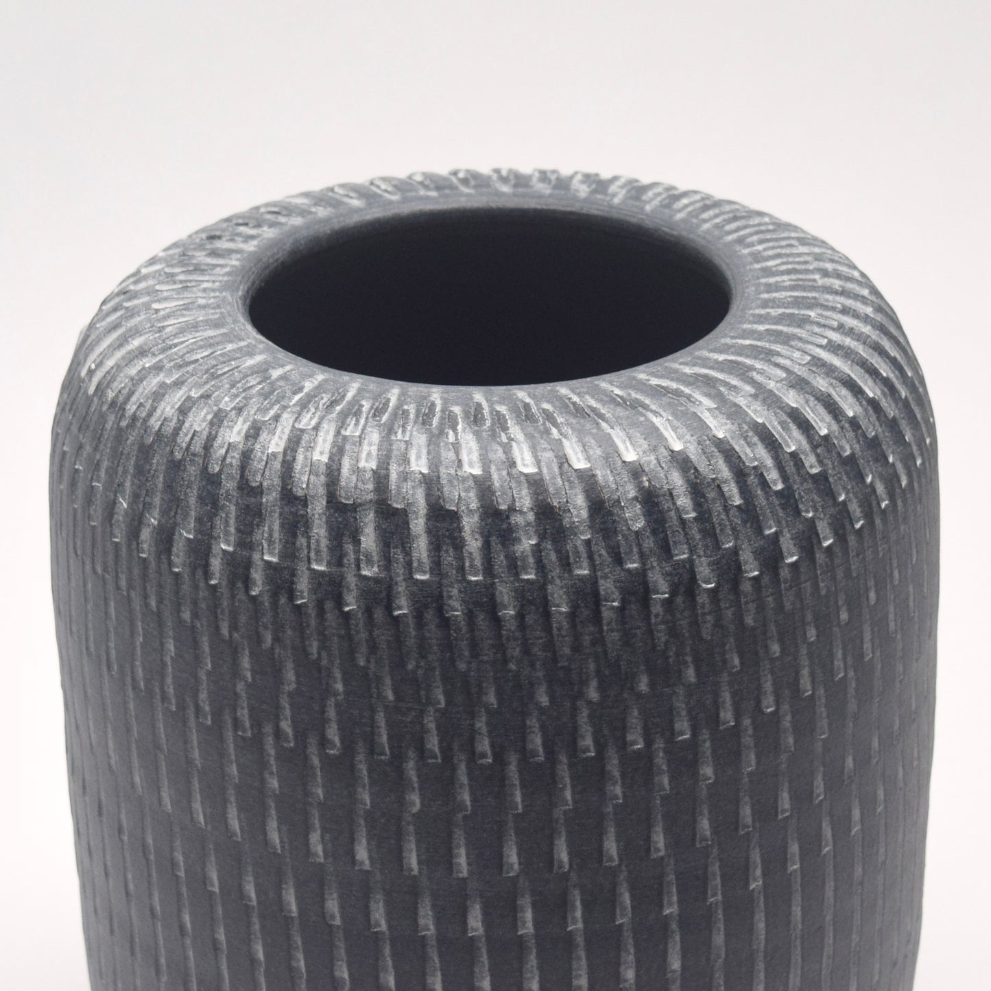 Grey linear patterned cylindrical pillar shaped vase