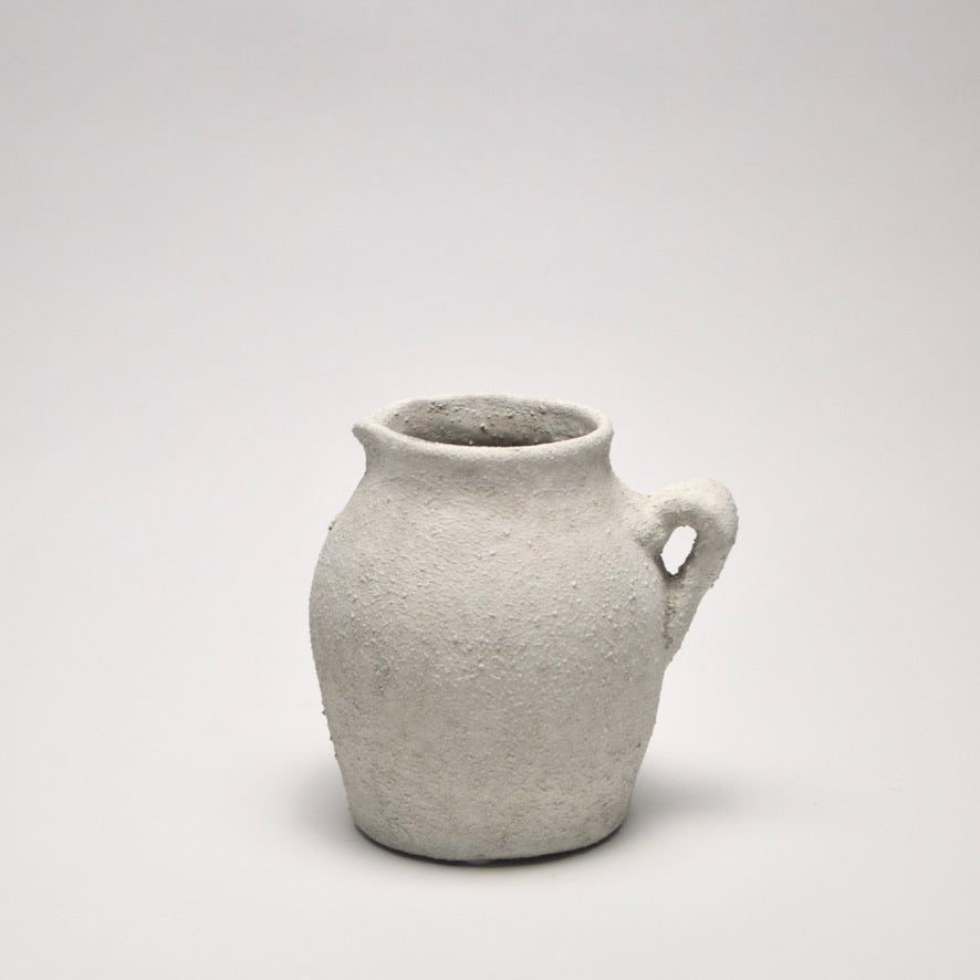 Small ceramic off-white vase with a textured surface for modern home styling