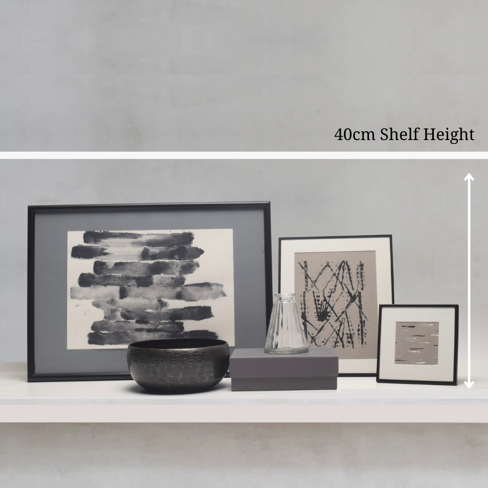 Decorative shelf with framed artworks and a bowl, showing a 40cm shelf height measurement.