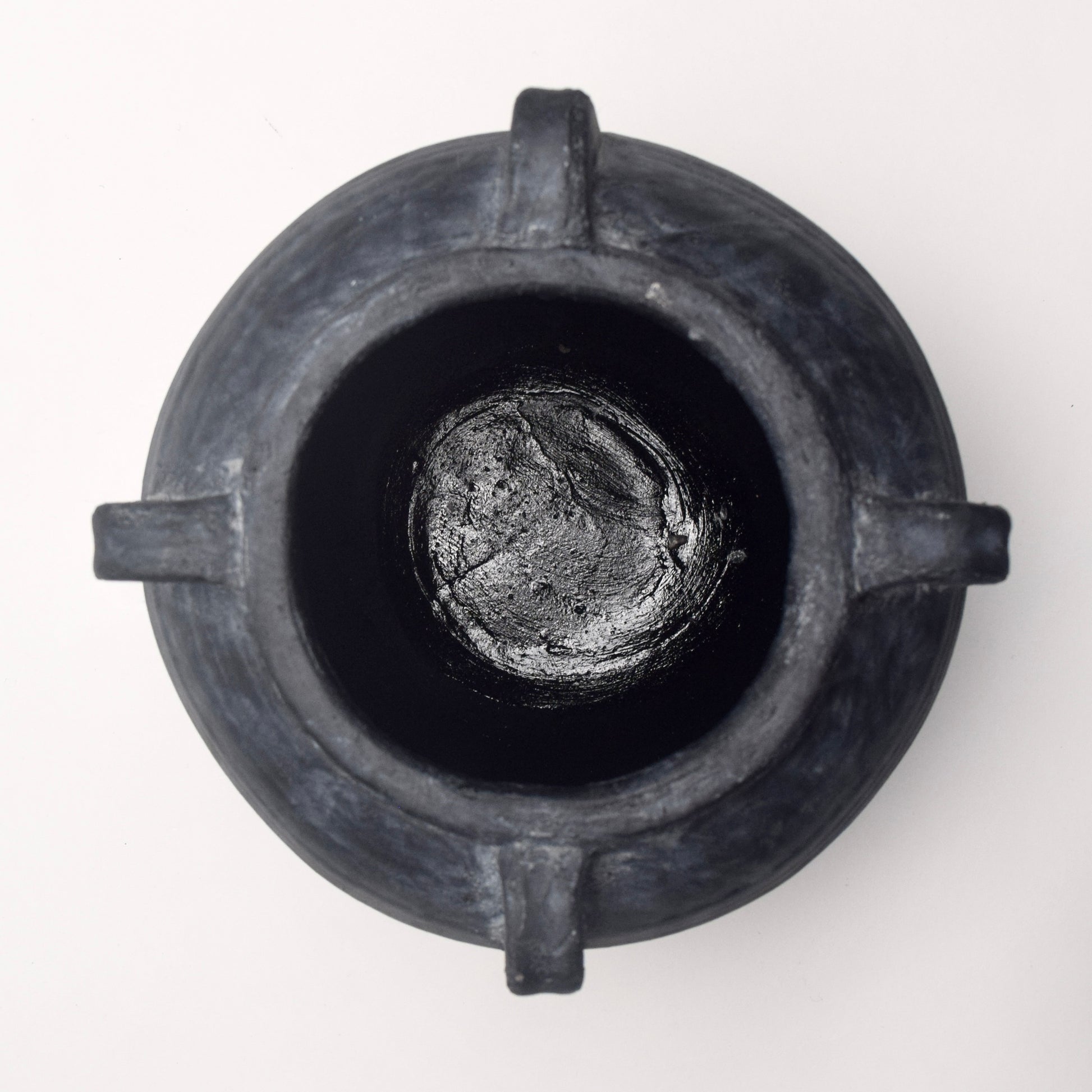 Black ceramic vase with 4 handles and textured surface