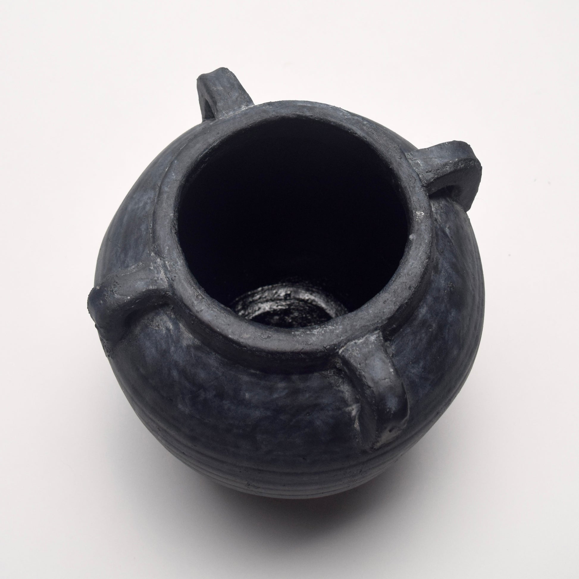 Black ceramic terracotta vase with four handles with rustic texture