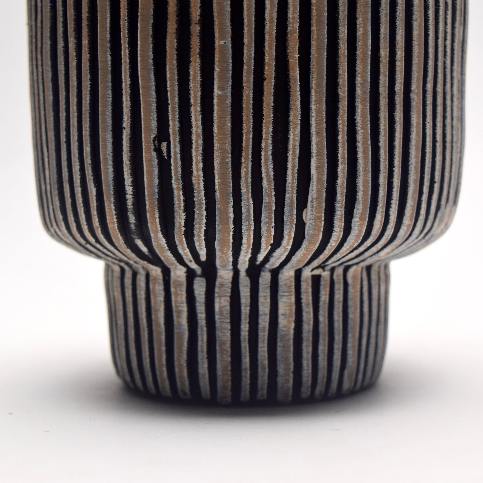 Cylindrical ceramic planter with ribbed texture and black & neutral vertical stripes and pedestal shape