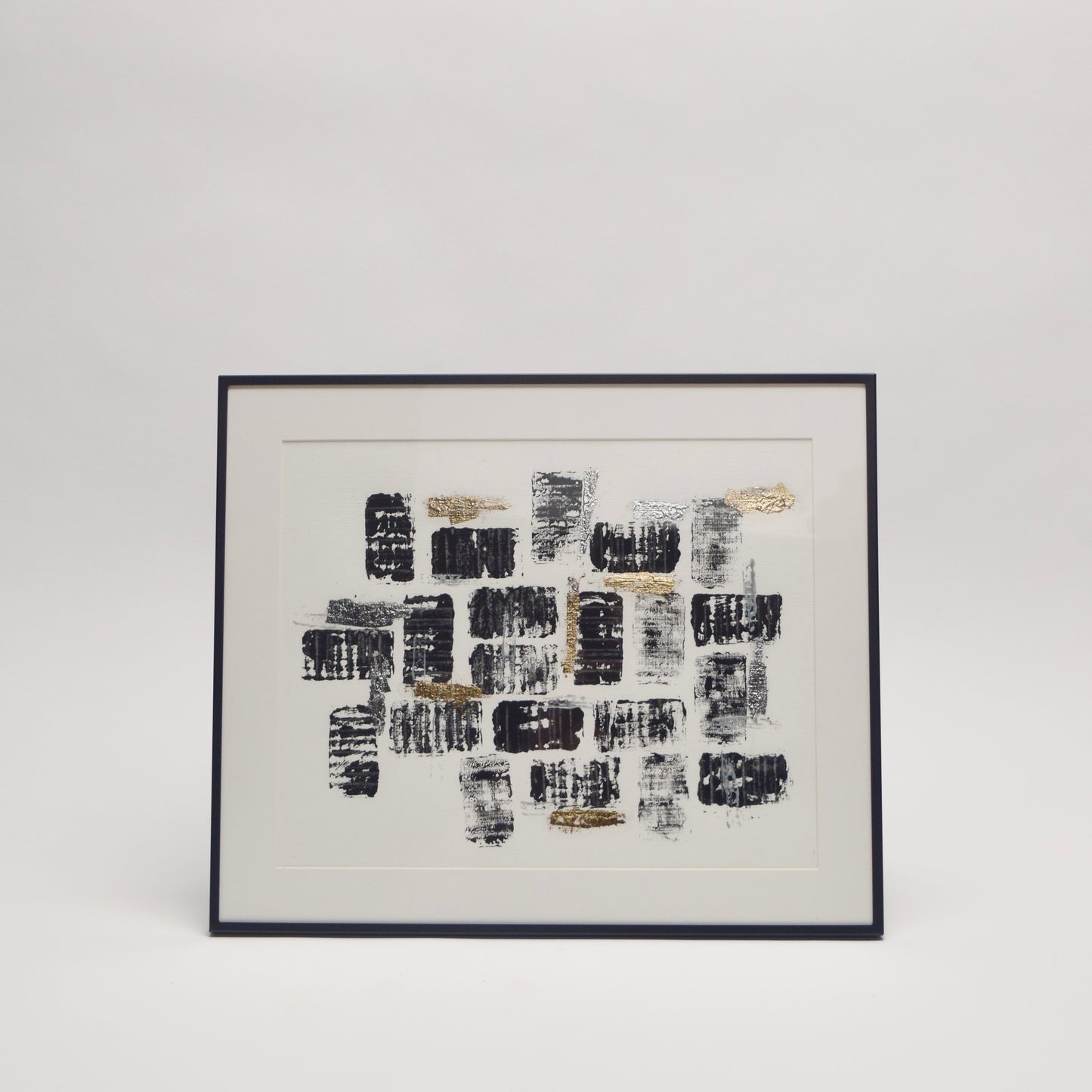 Framed abstract artwork with black and gold metallic pattern for unique home interior styling