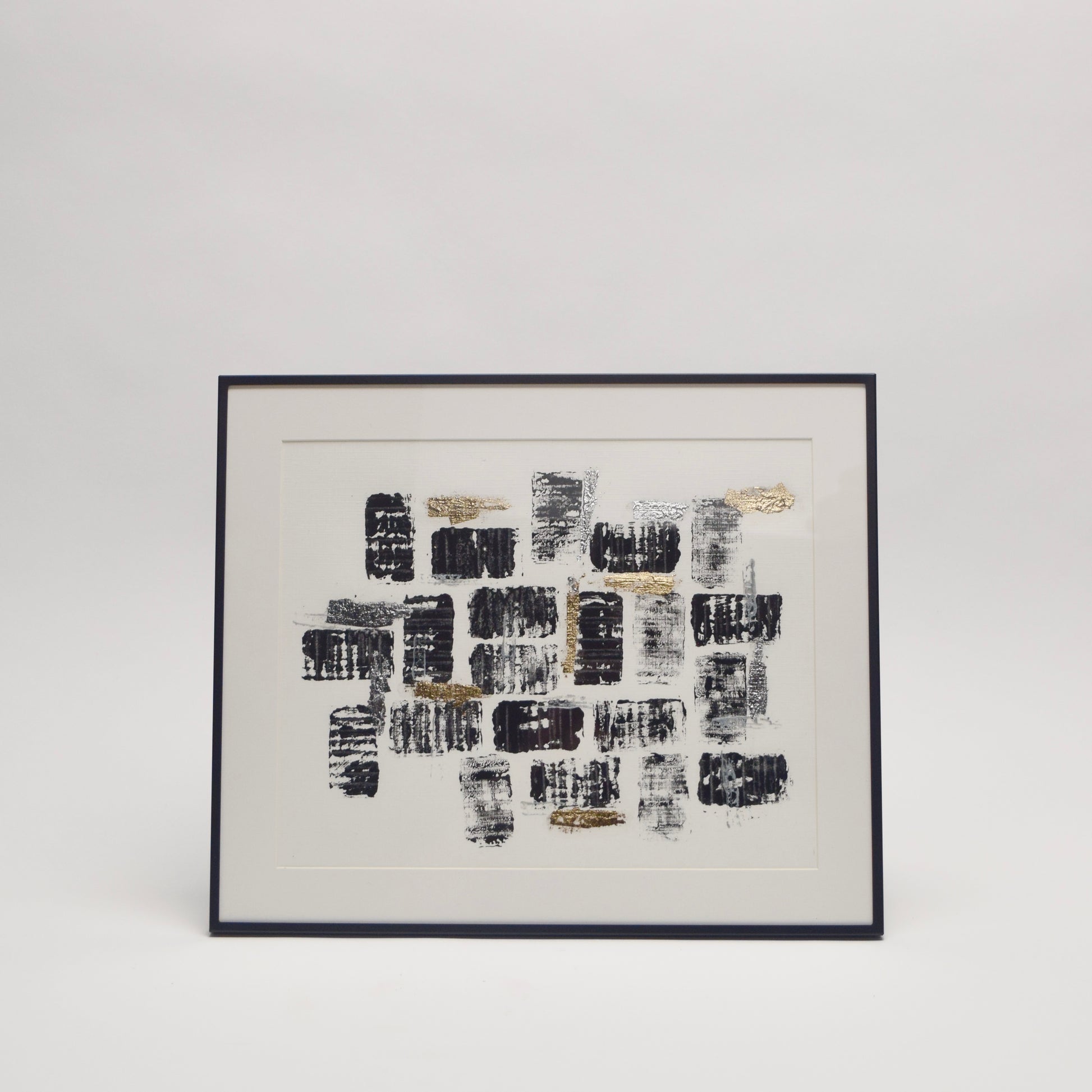 Framed abstract artwork with black and gold metallic pattern for unique home interior styling