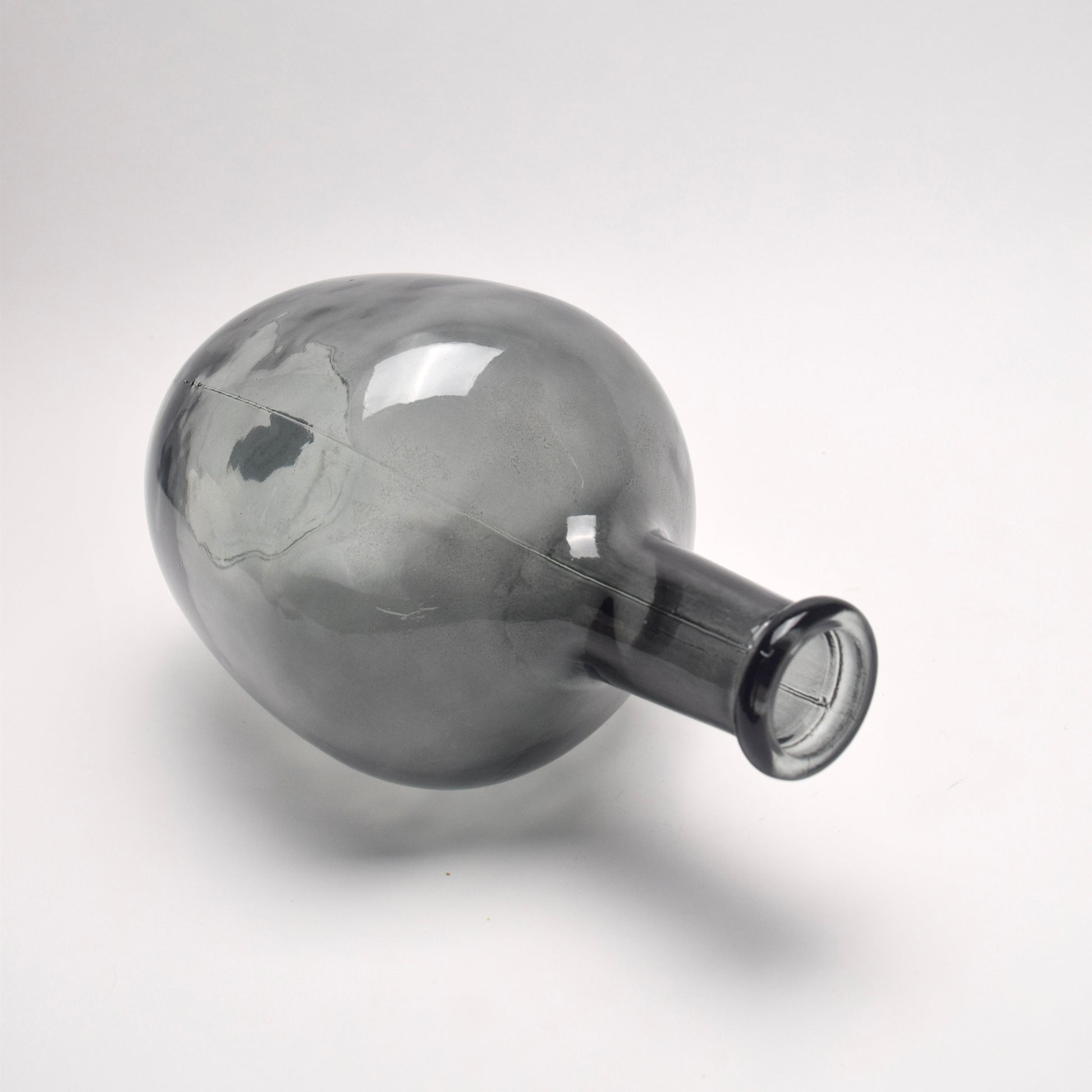 Glass bottle vase with a spherical shape and long neck