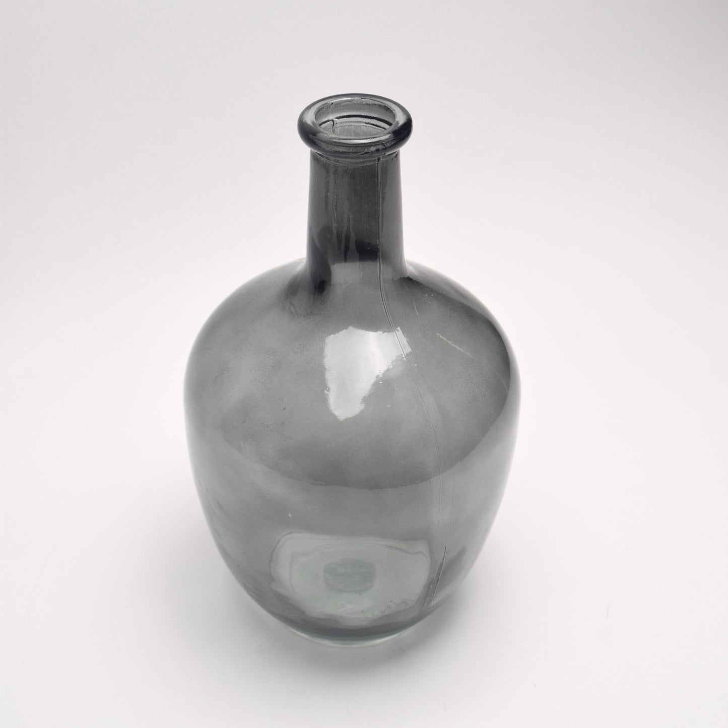 Grey glass bottle vase on white background