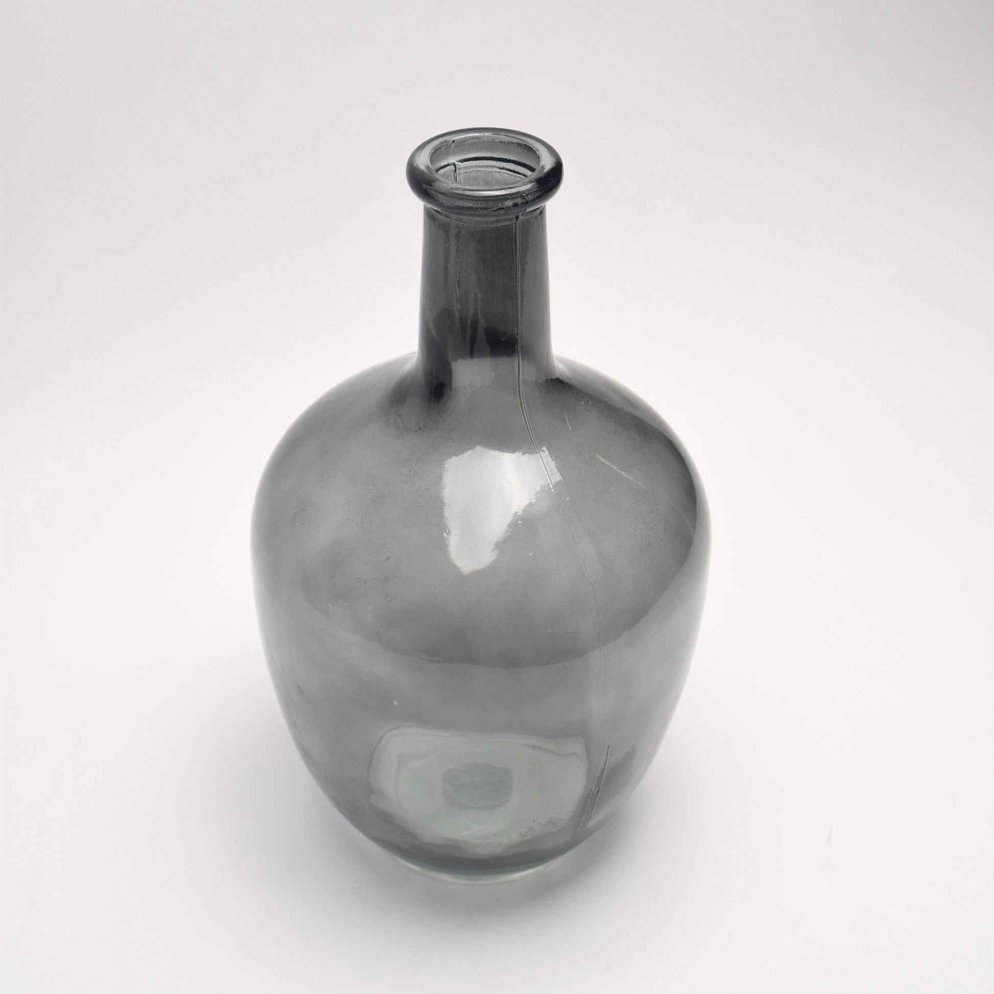Grey glass bottle vase on white background