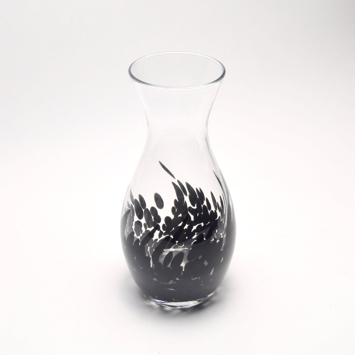 Clear glass vase with a decorative black pattern