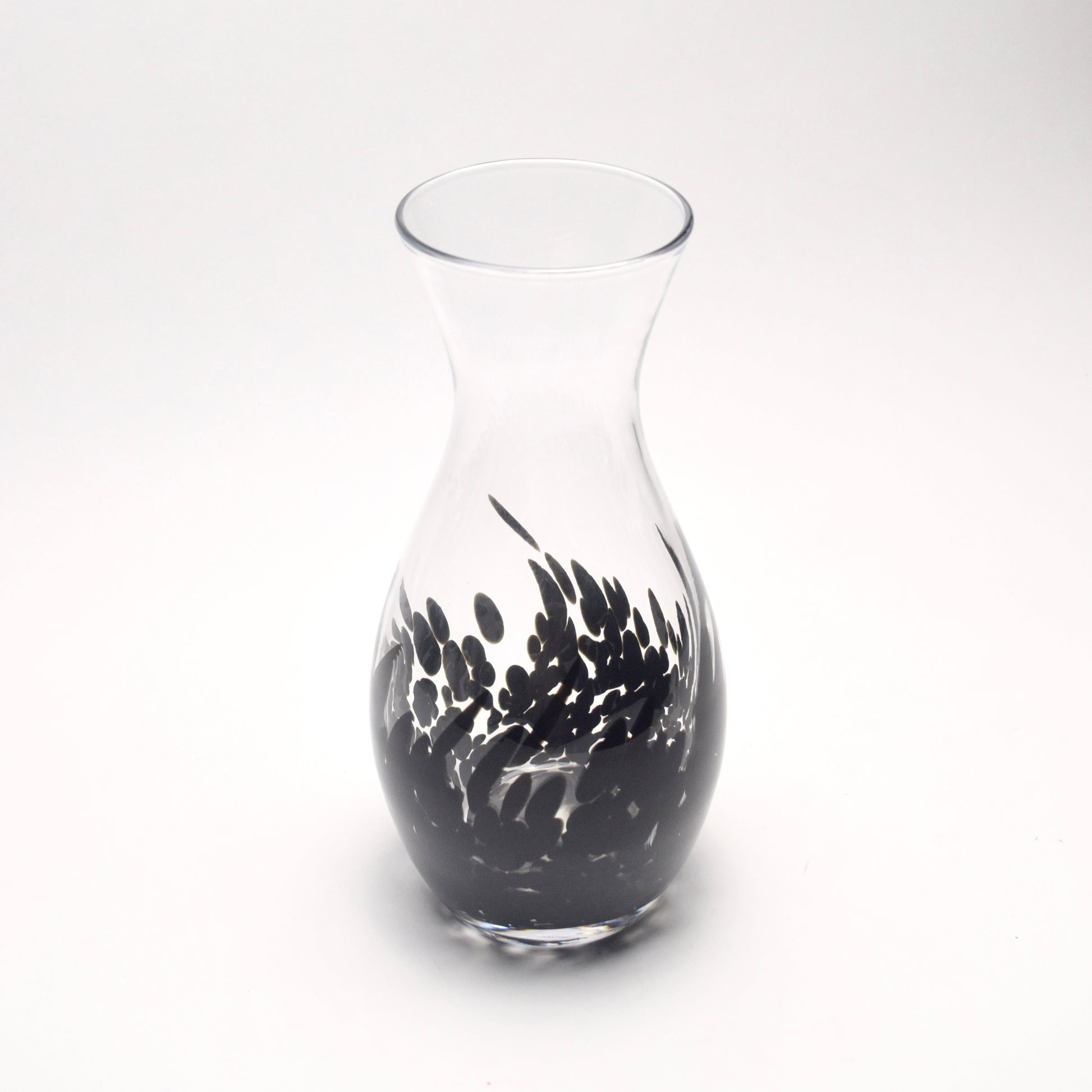 Clear glass vase with a decorative black pattern