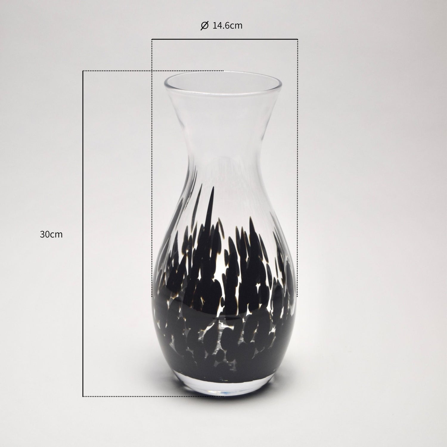 Glass vase with black abstract design and measurements on a light grey background