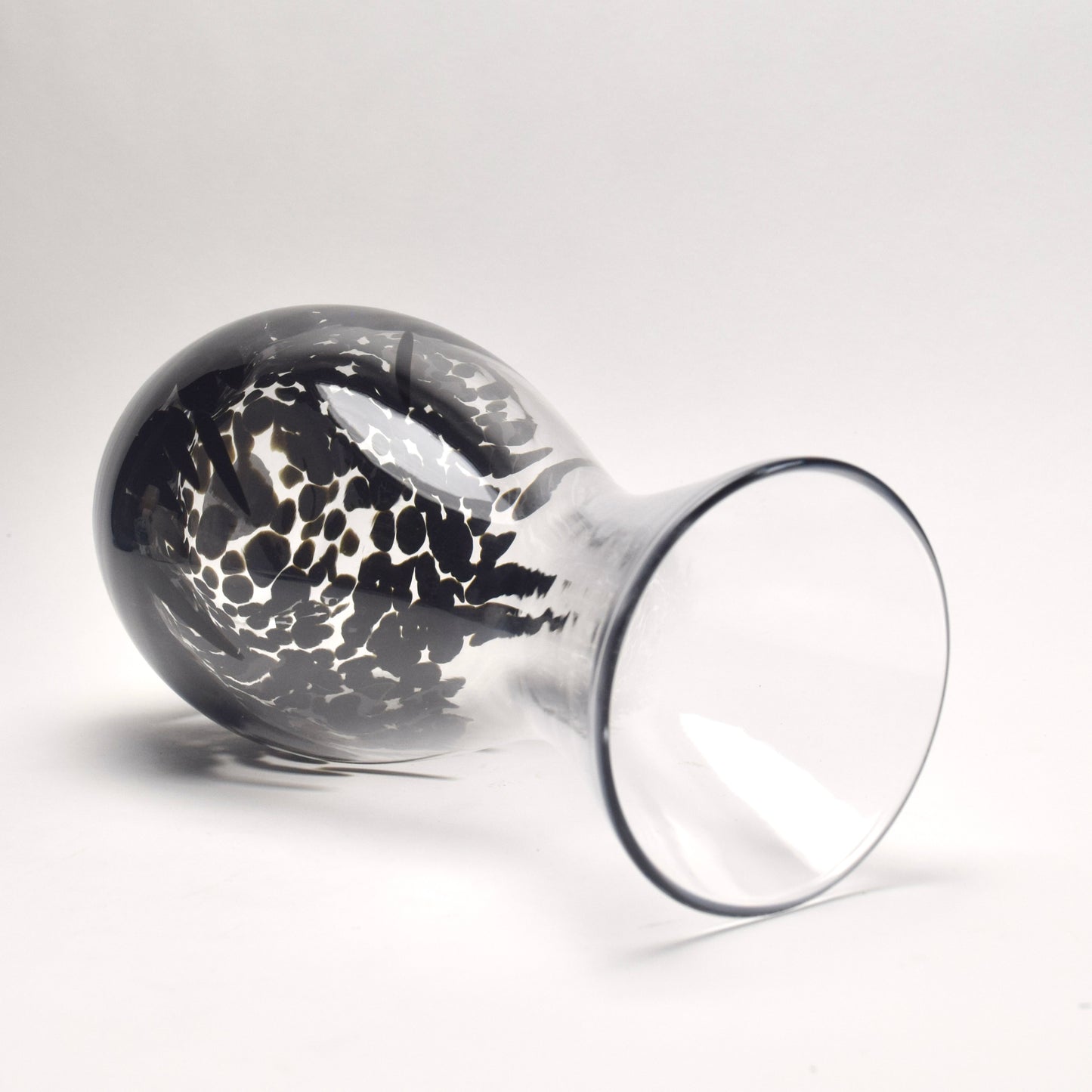 Clear glass vase with a decorative black pattern on it's side to show the shape and detail