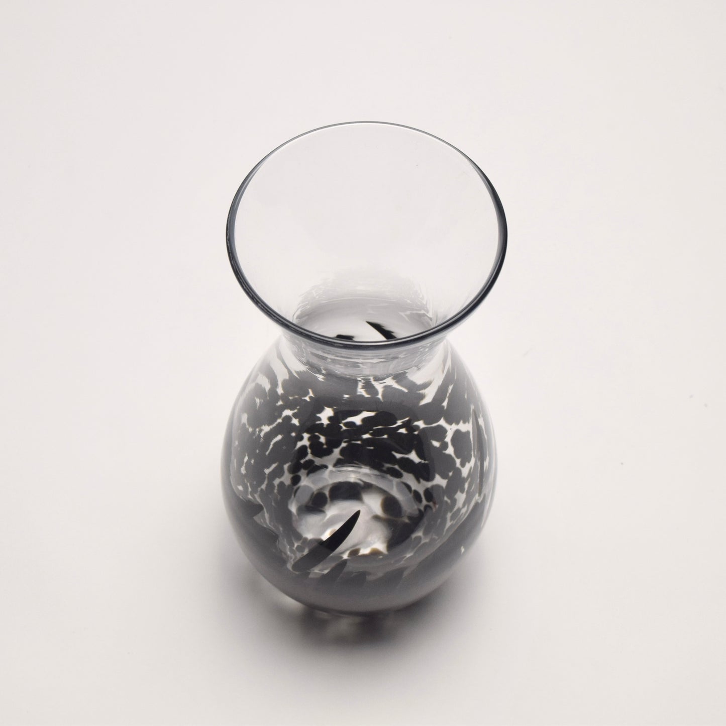Top view of a glass vase with black abstract design 