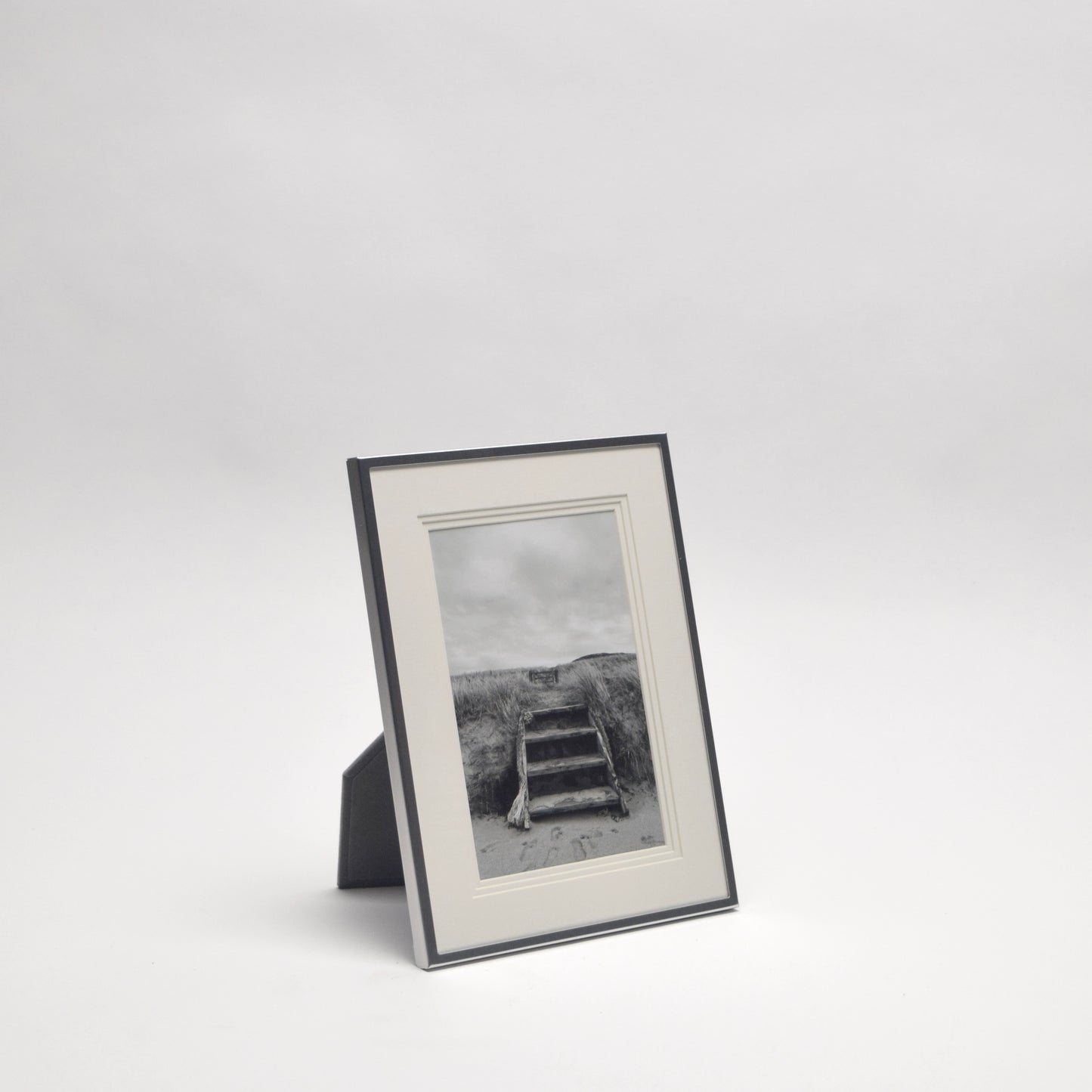 Framed black and white photograph of a relaxing beach scene for home styling