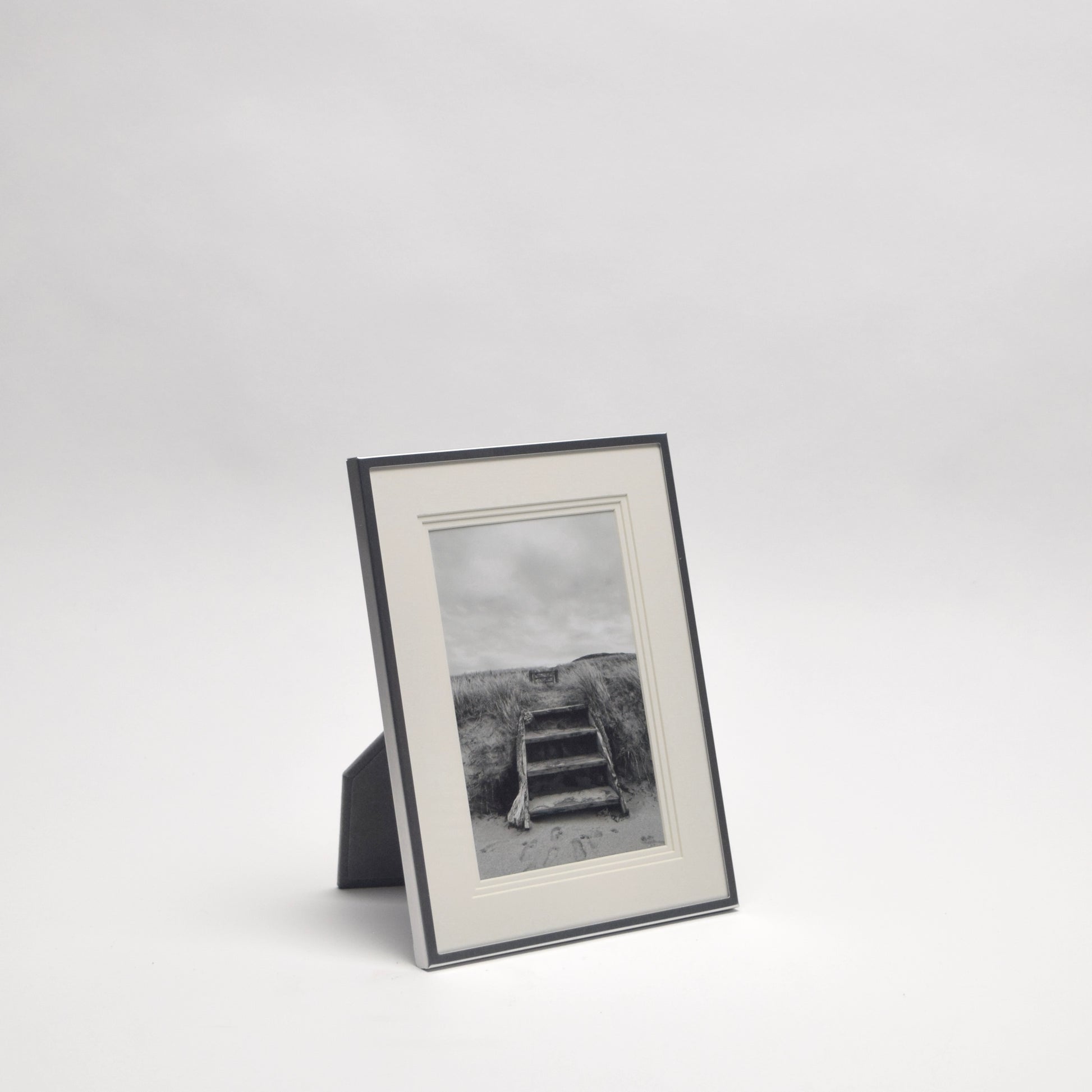 Framed black and white photograph of a relaxing beach scene for home styling