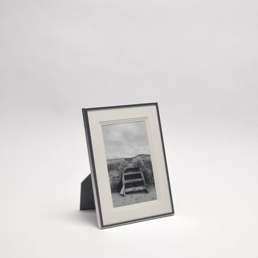 Framed black and white photograph of a relaxing beach scene for home styling