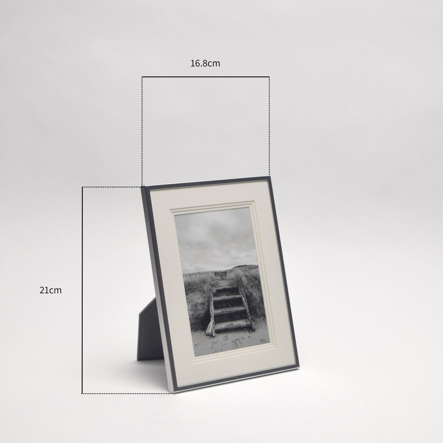 Silver photo frame with a black and white photograph showing measurement annotations