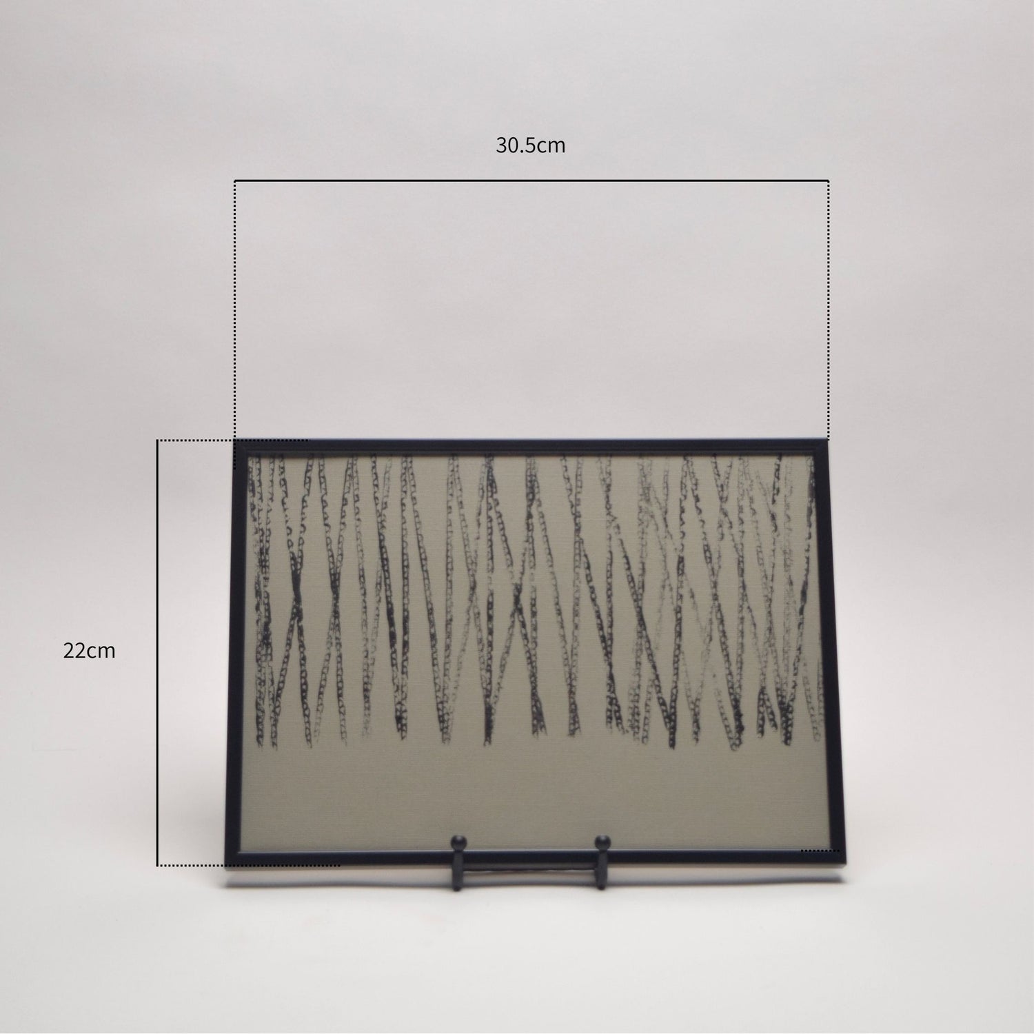 Framed artwork in black thin frame with measurements on a white background
