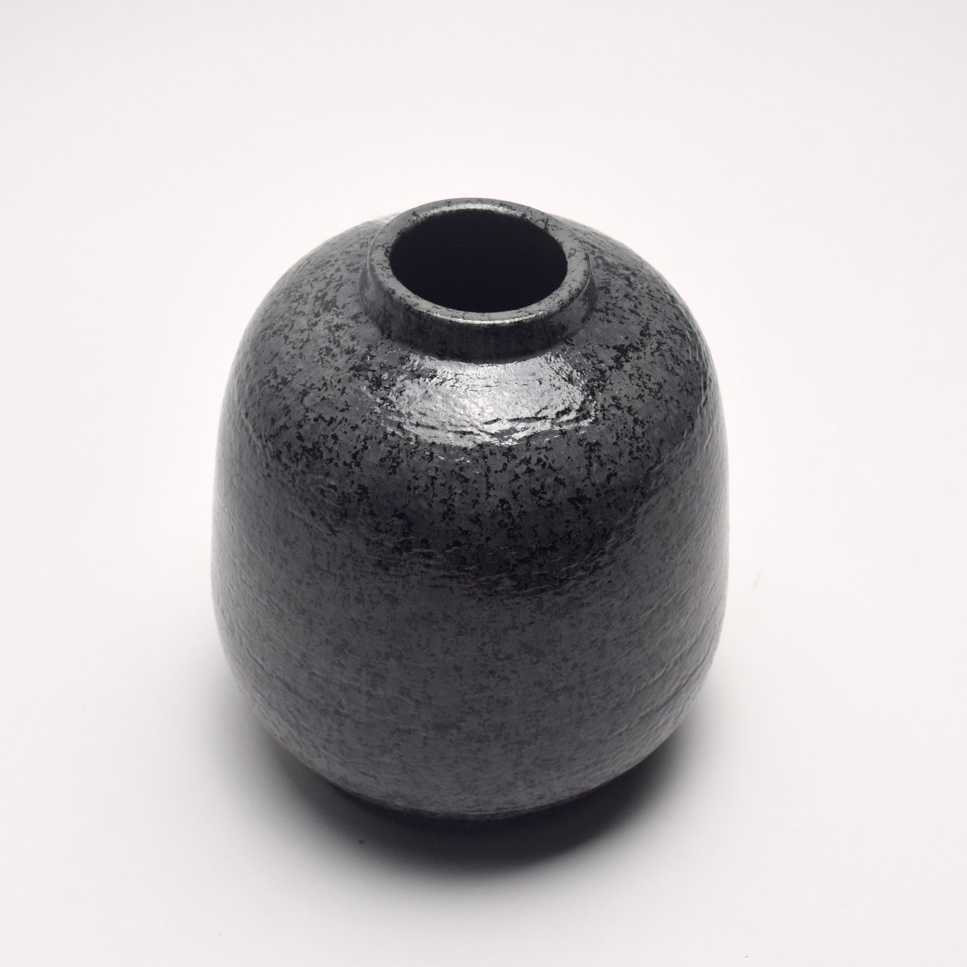 Dark grey, charcoal terracotta vase with mottled surface pattern and rounded shape