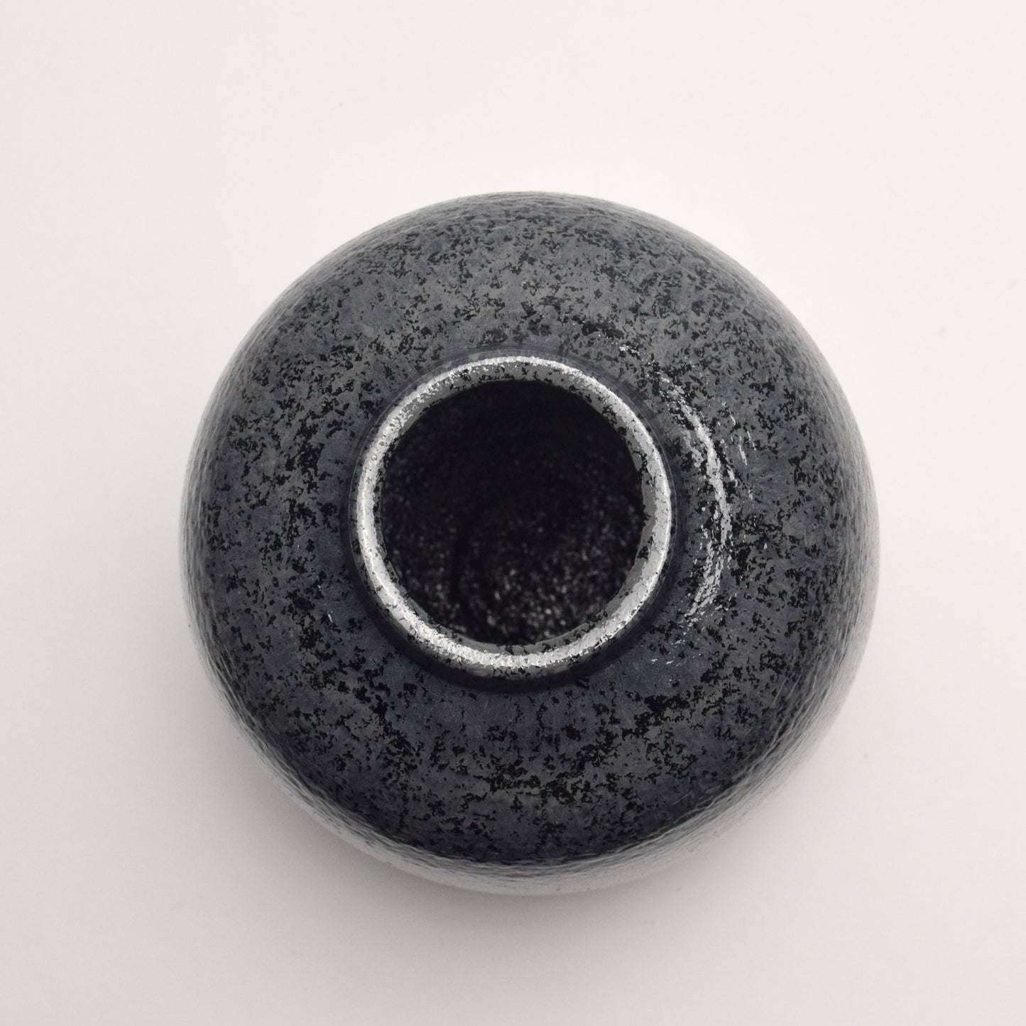 Top circular view of dark grey speckled ceramic vase