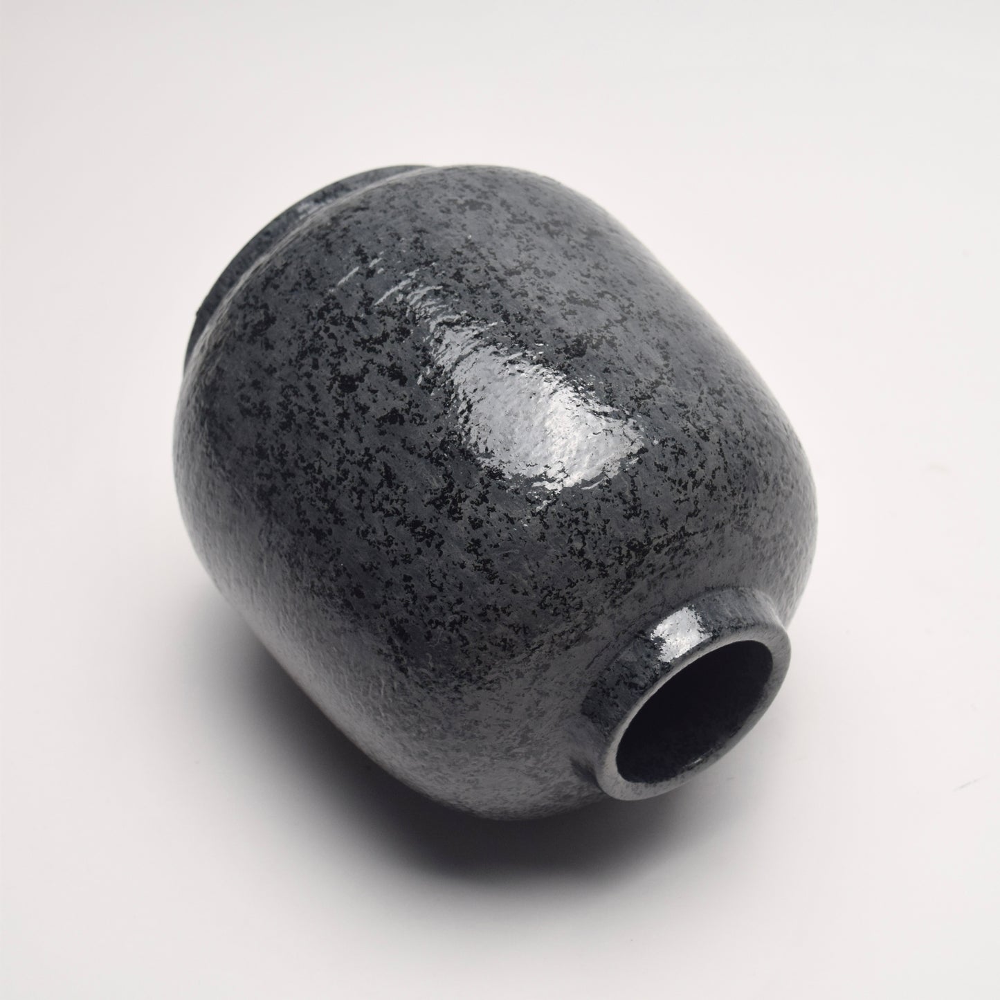 Dark grey, charcoal terracotta vase with mottled surface pattern on its side