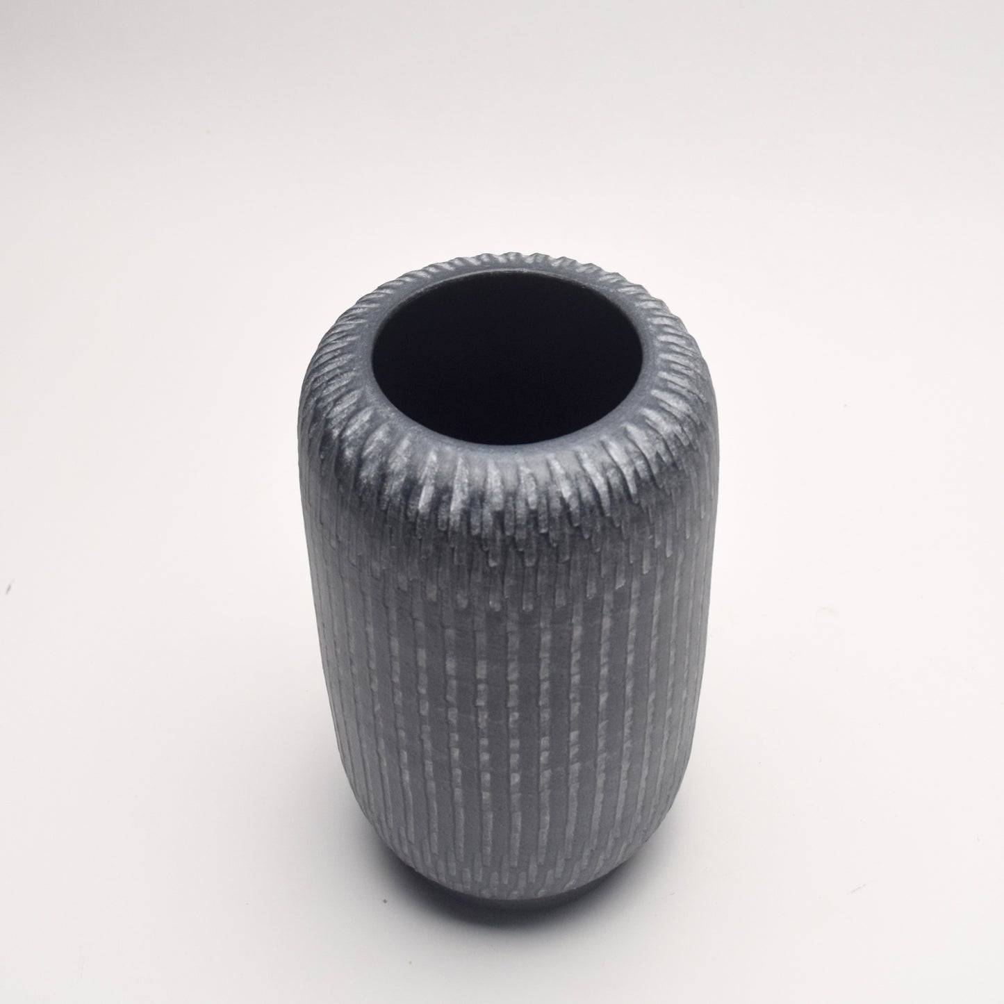 Textured grey terracotta vase with cylindrical shape