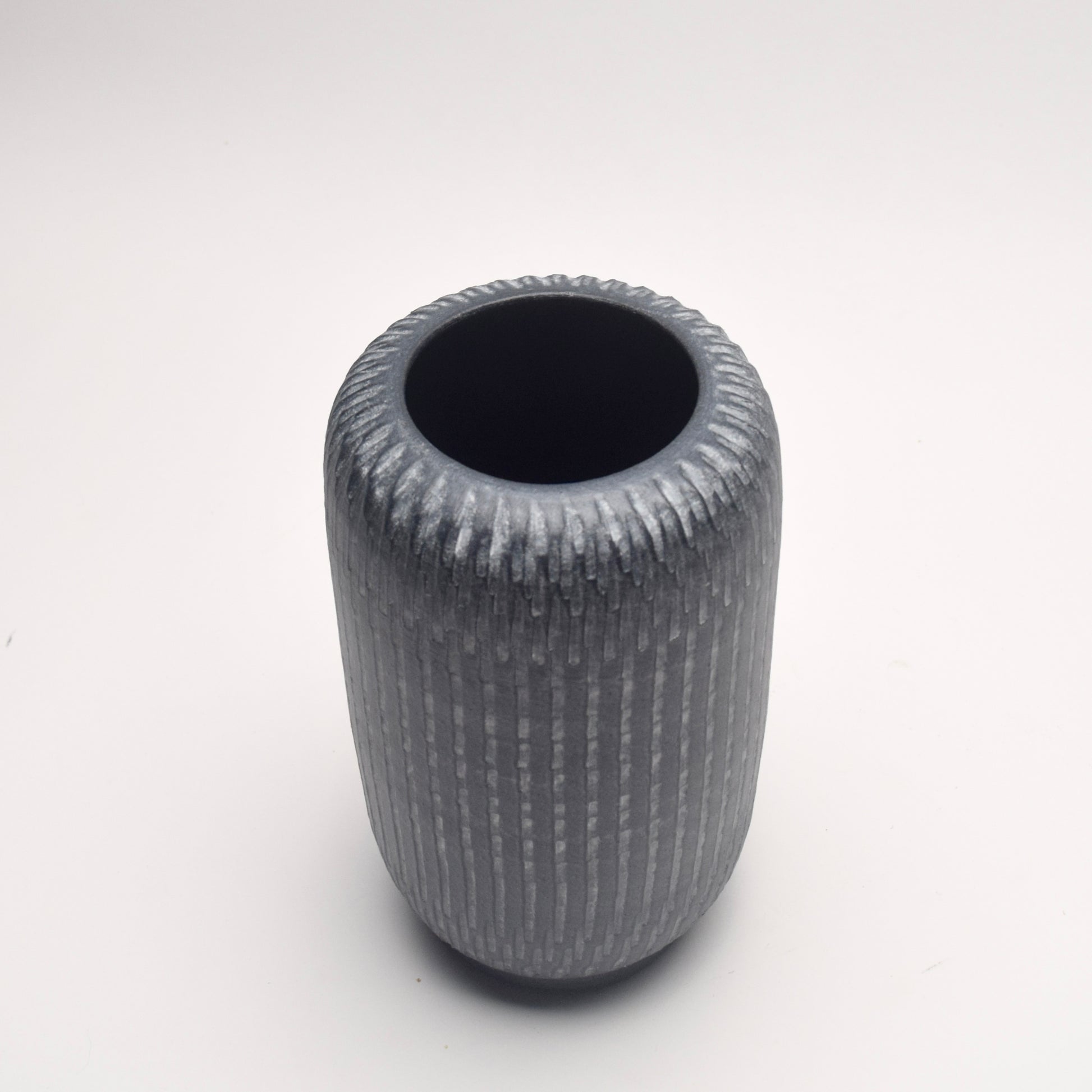 Textured grey terracotta vase with cylindrical shape