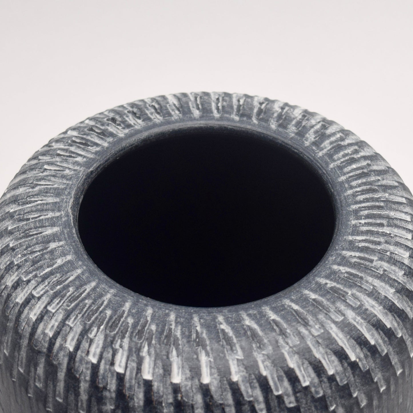 Grey Terracotta Vase view of the top with intricate white vertical line patterns