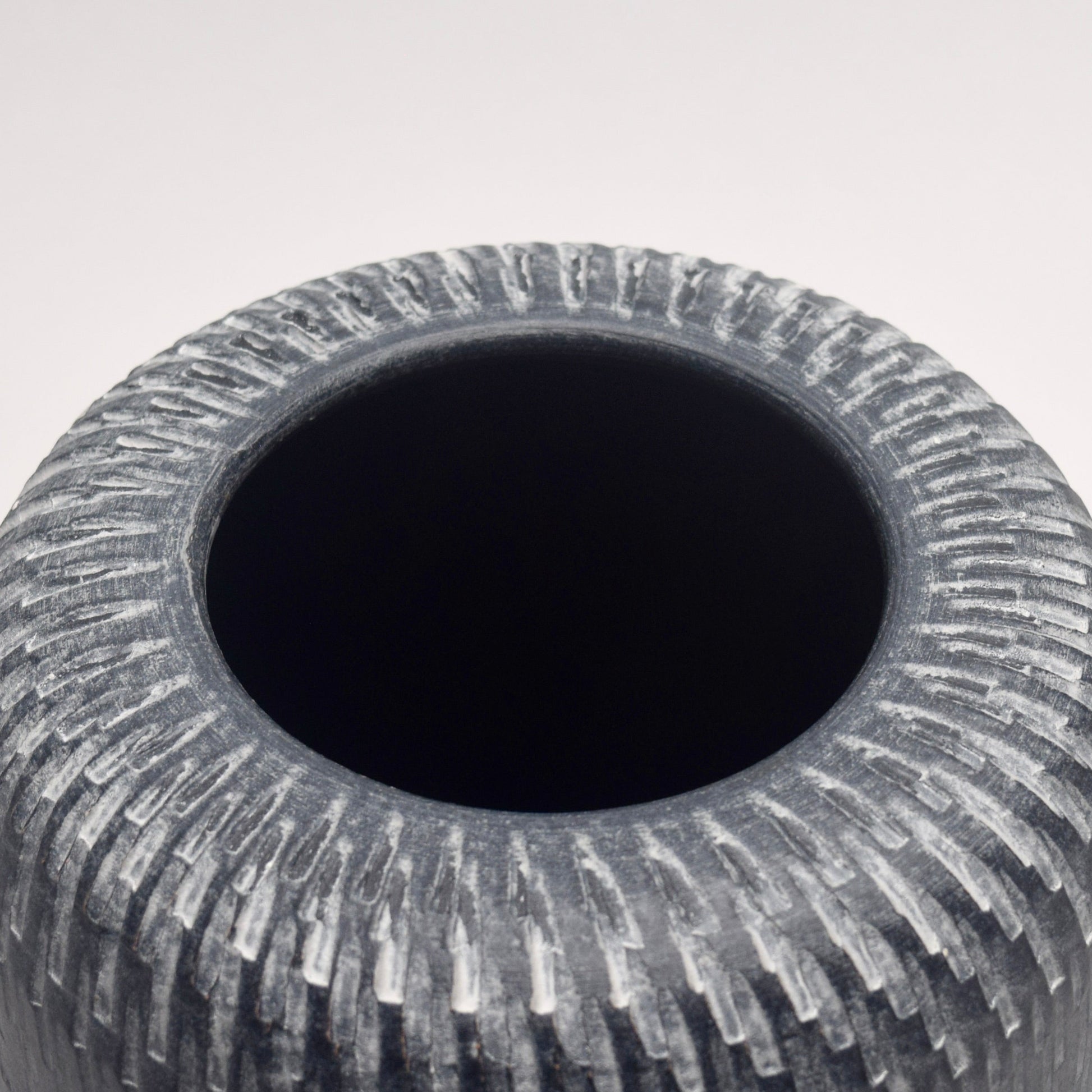 Grey Terracotta Vase view of the top with intricate white vertical line patterns