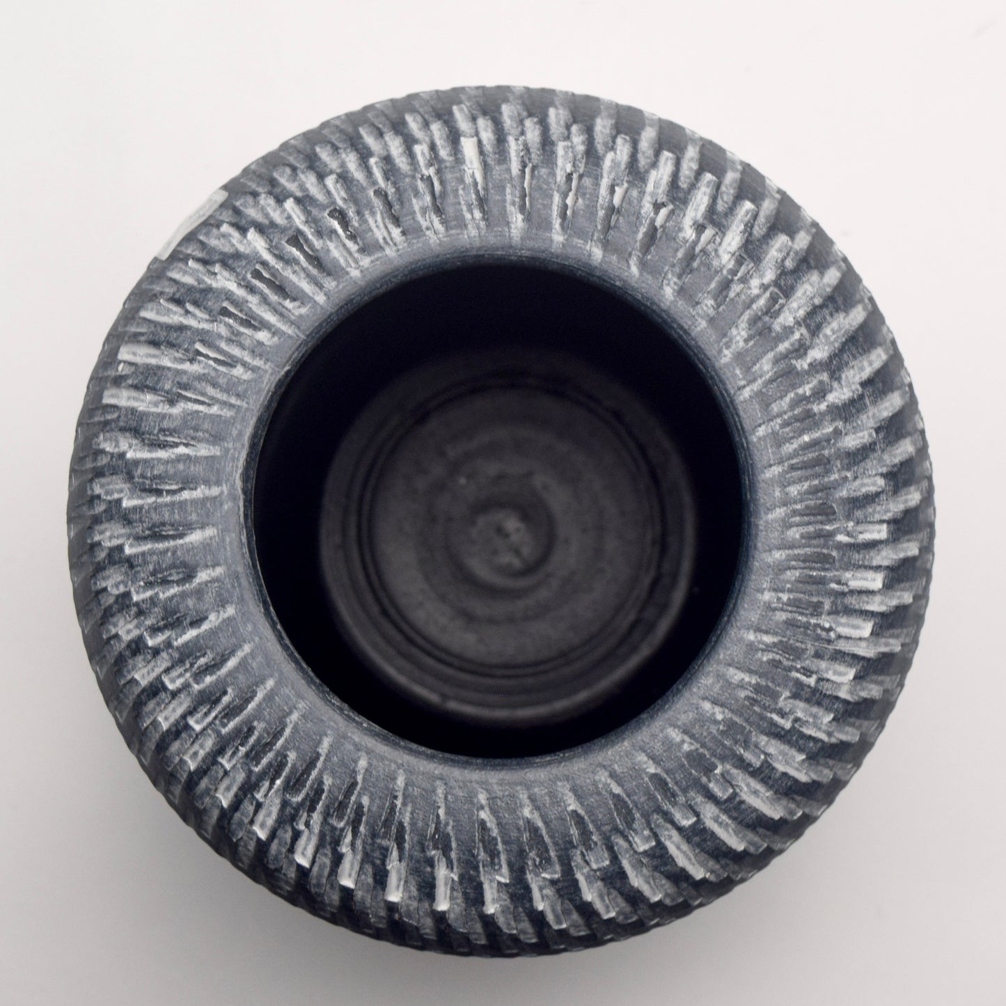 Circular top view of cylindrical pillar grey terracotta vase