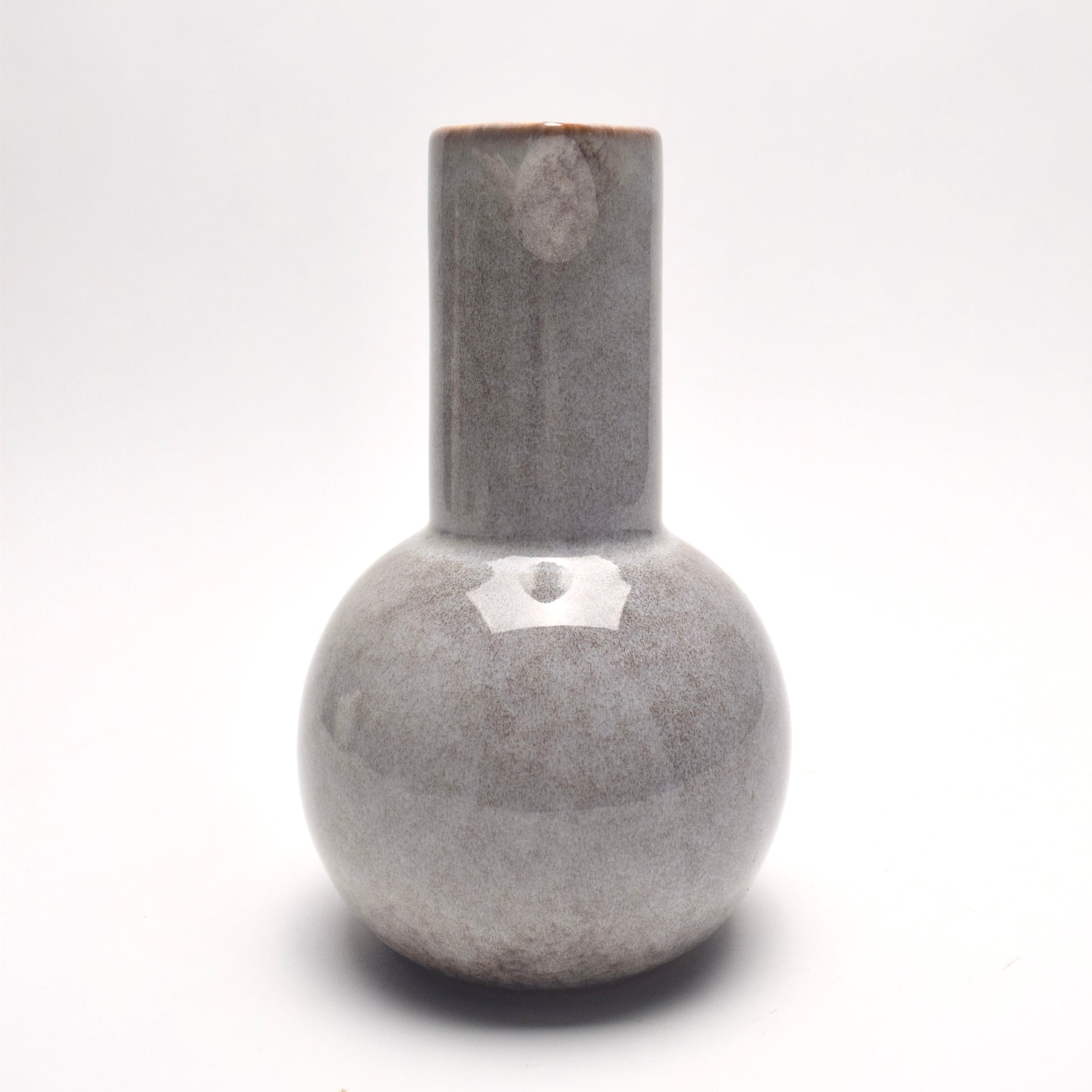 Light grey ceramic glazed jug with brown speckles, view from straight on