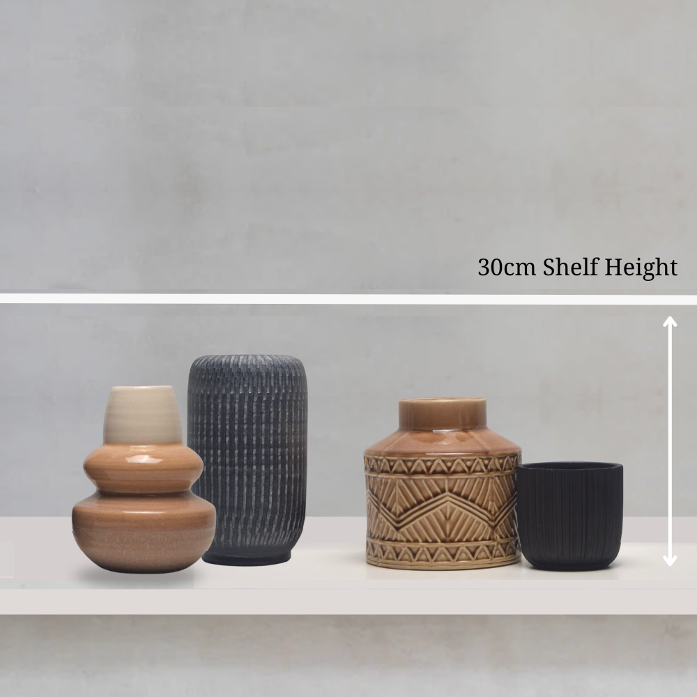 Four ceramic vases of different designs on a shelf with a grey background and measurement text.