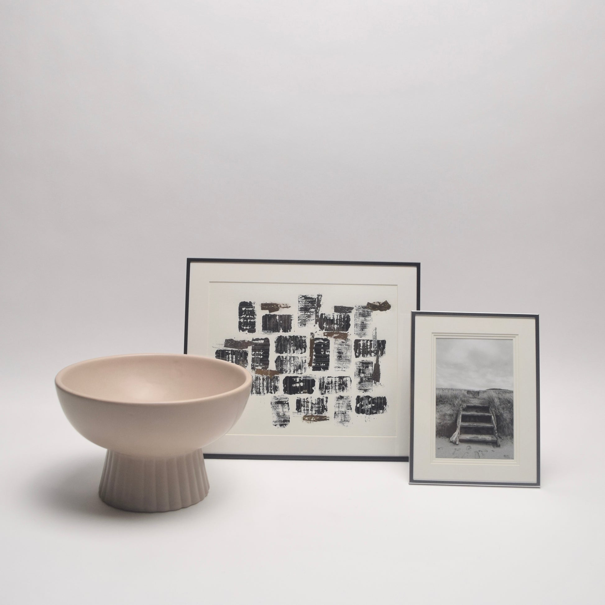 Decorative bowl and framed artworks for shelf styling