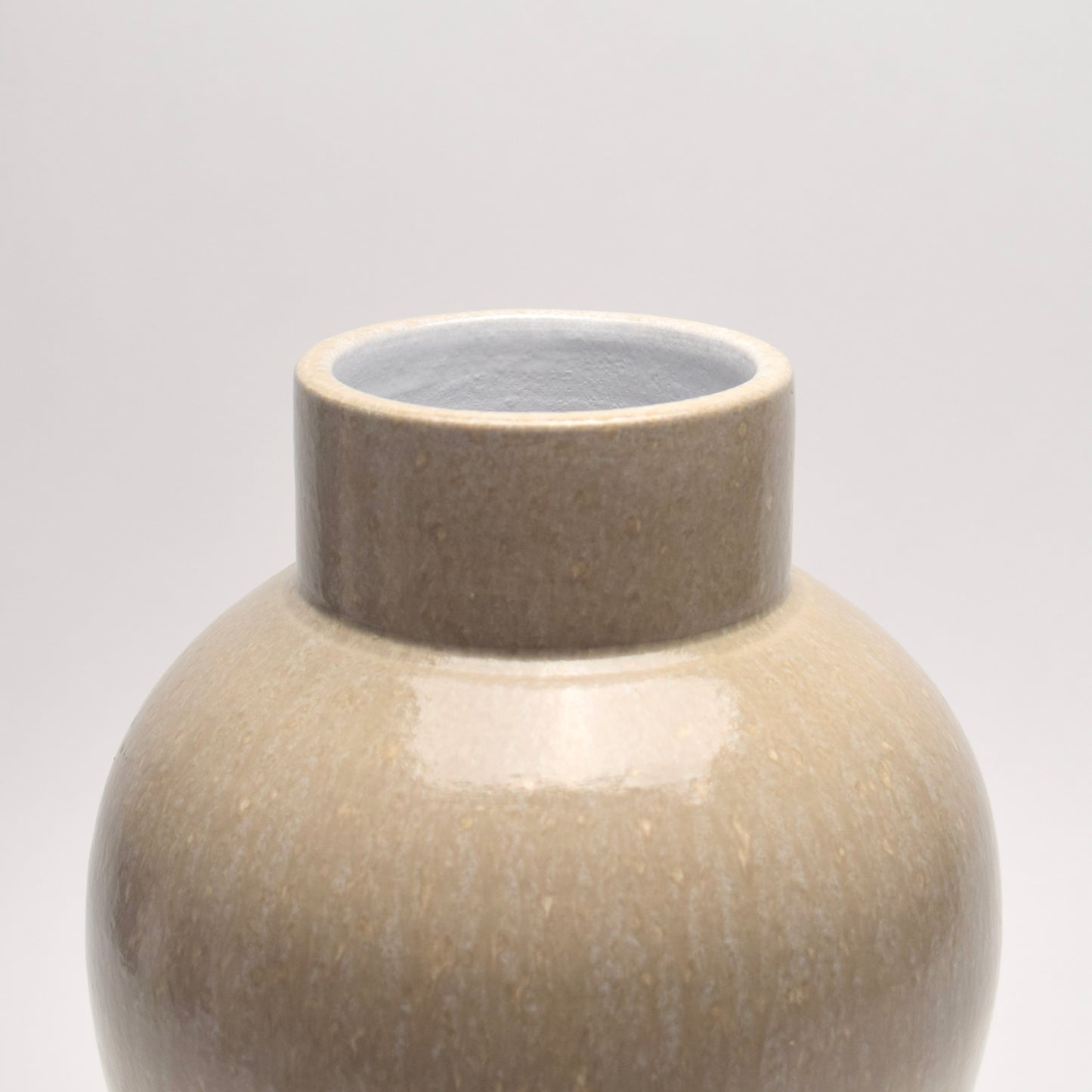 Top of a ceramic vase with bold shape and patterned surface 