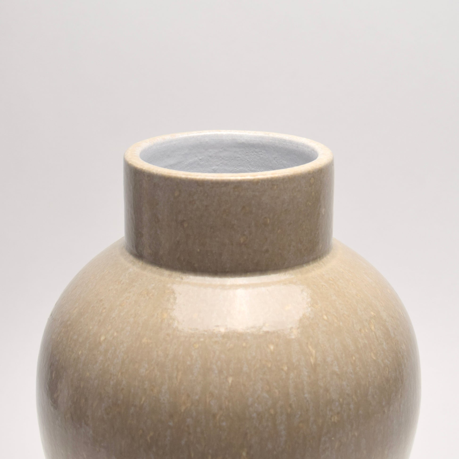 Top of a ceramic vase with bold shape and patterned surface 