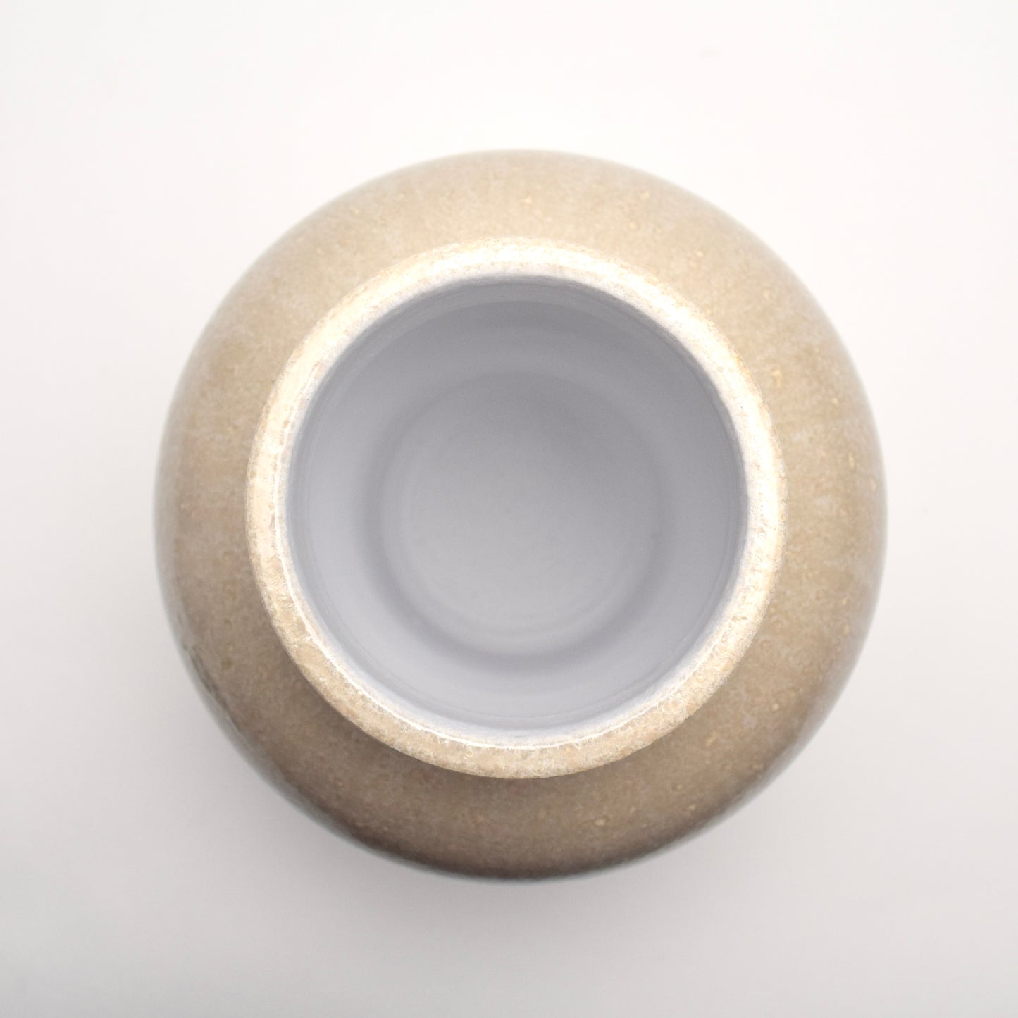 Top view looking down at neutral glazed terracotta vase