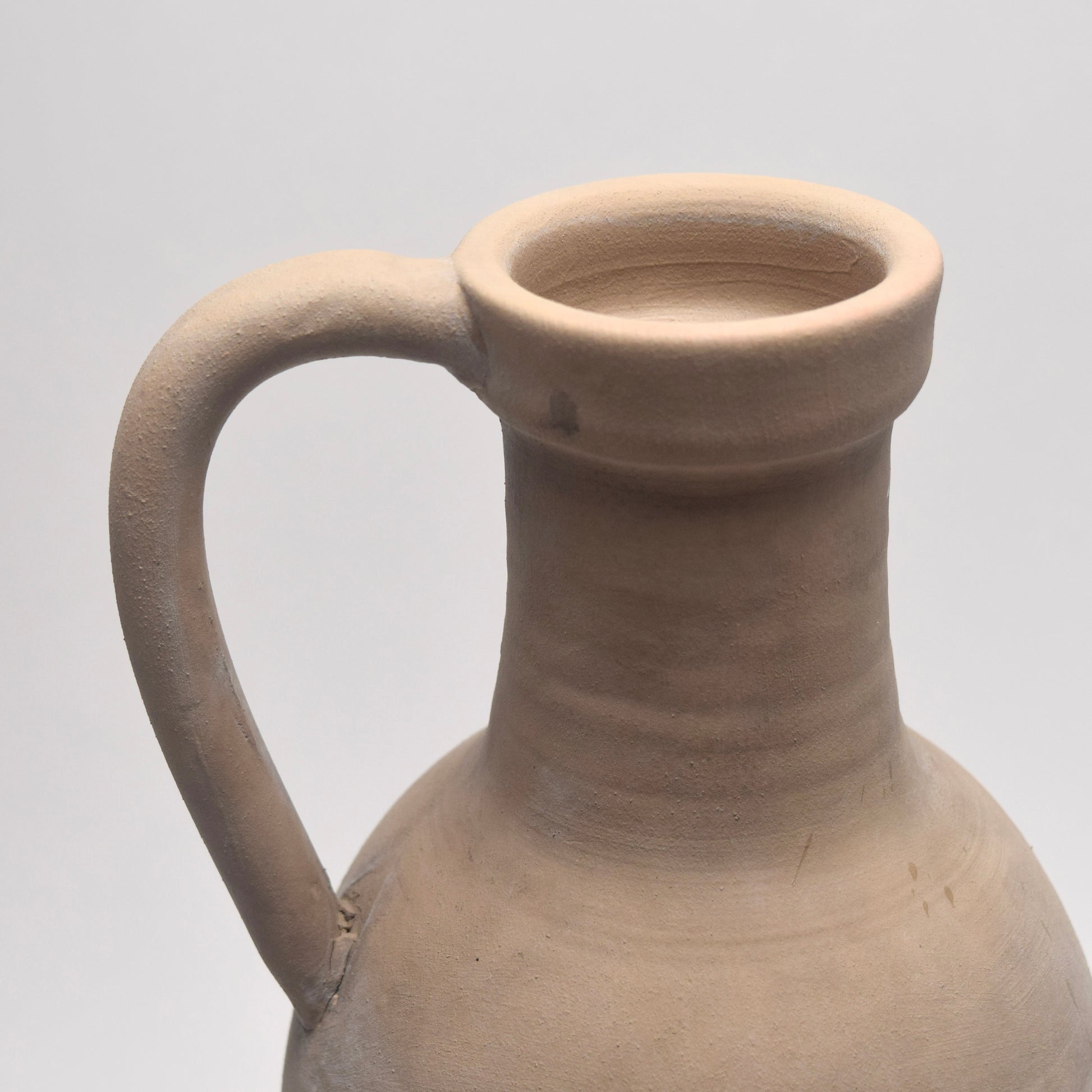 Close up of stone neutral jug's handle