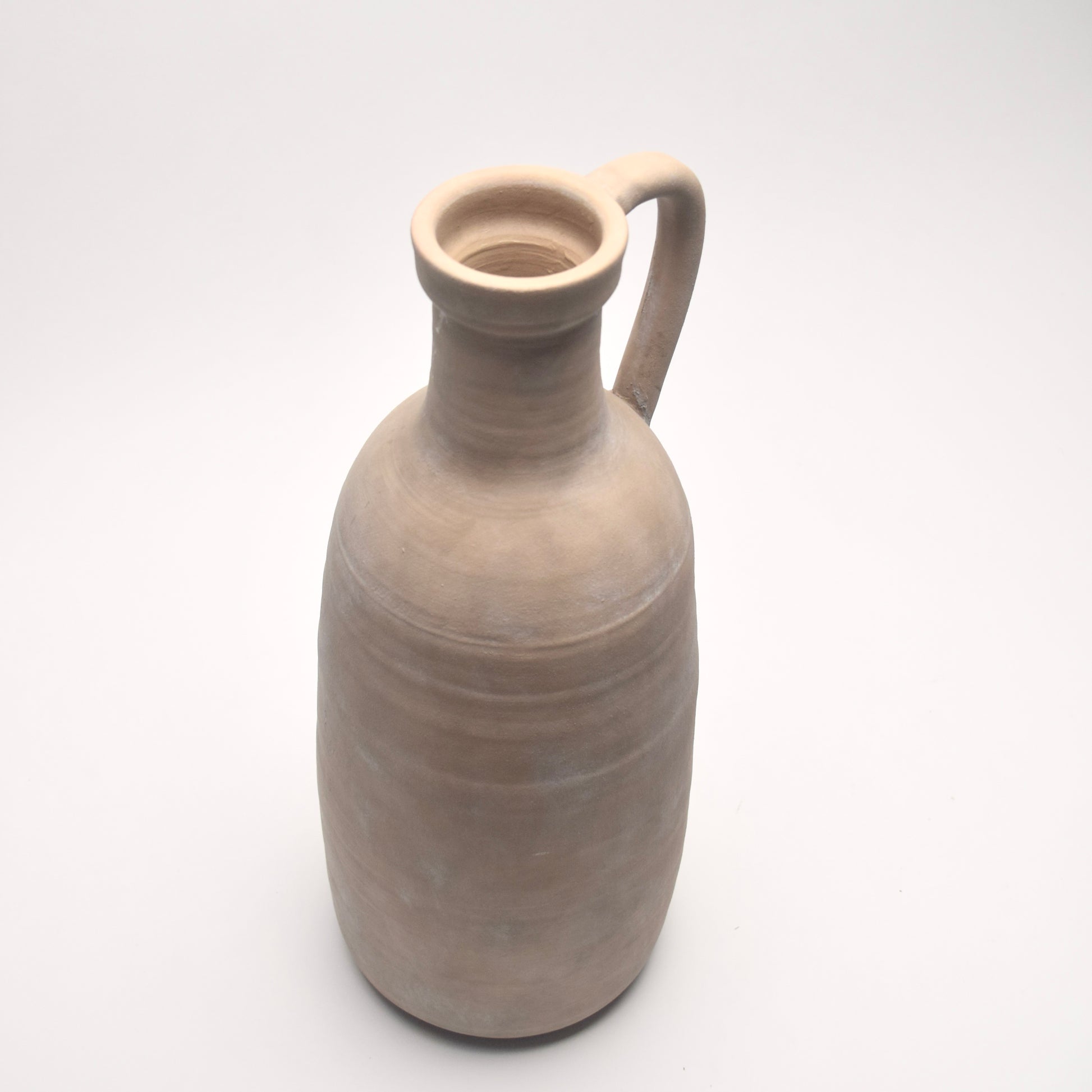 Neutral, beige, stoneware jug on a white background