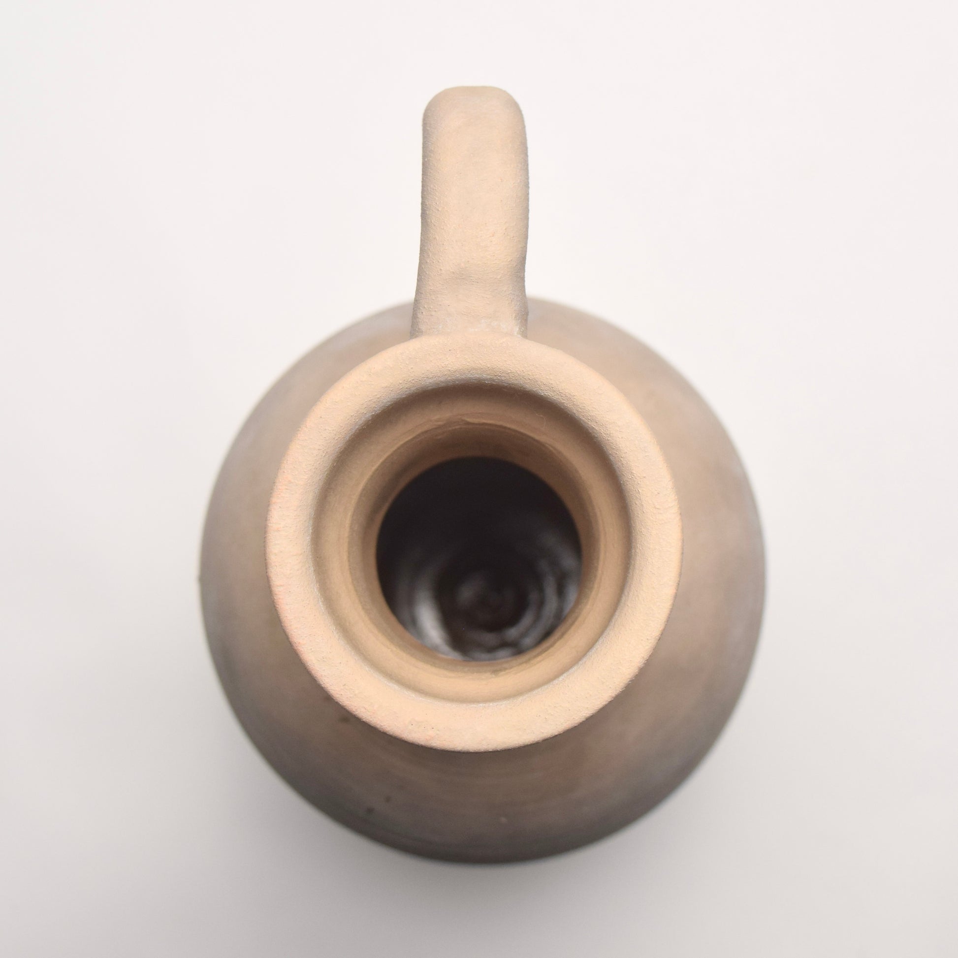 Close-up looking down at a neural slim stone jug vase