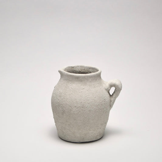 Small ceramic off-white vase with a textured surface for modern home styling 