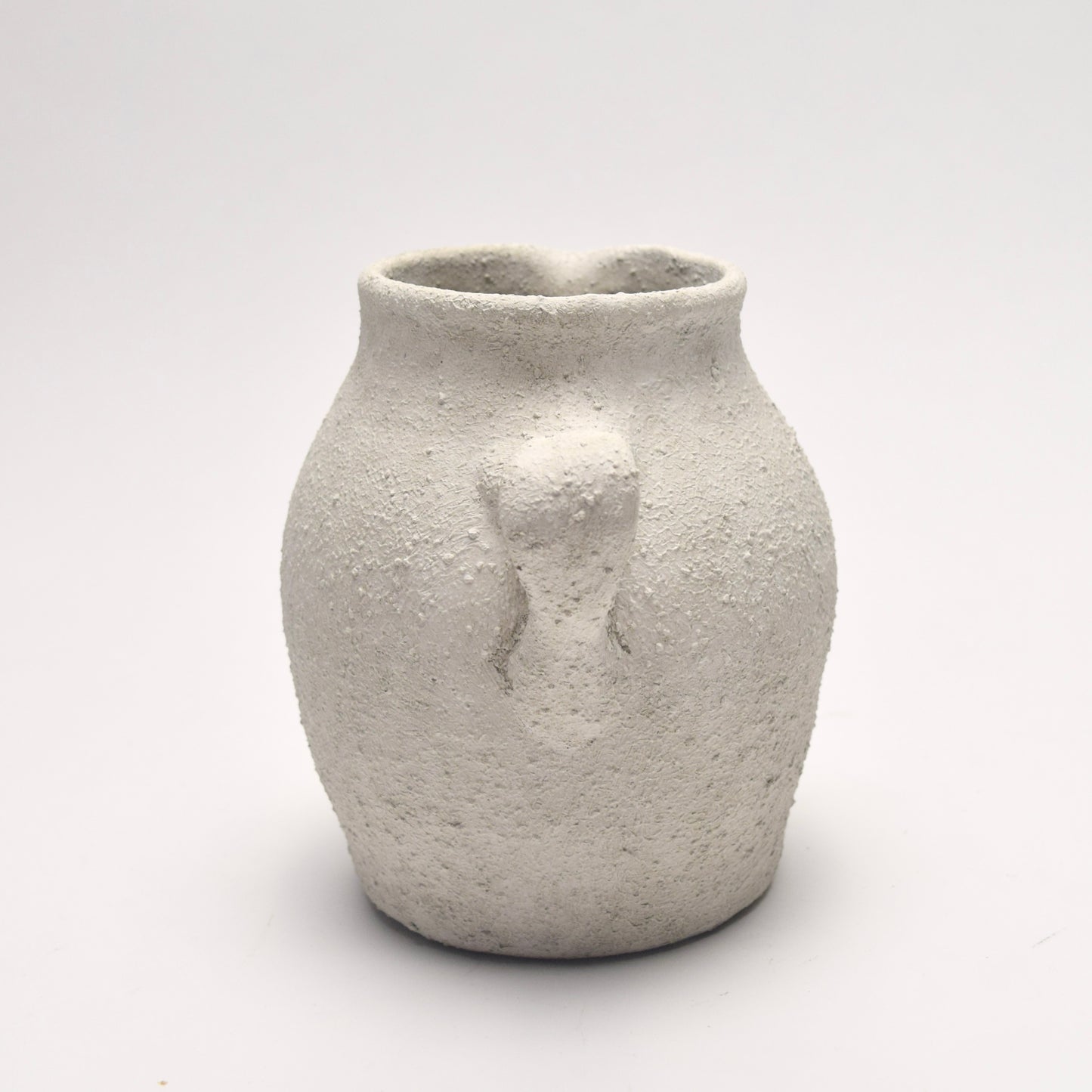 Back view of textured ceramic jug with handle 