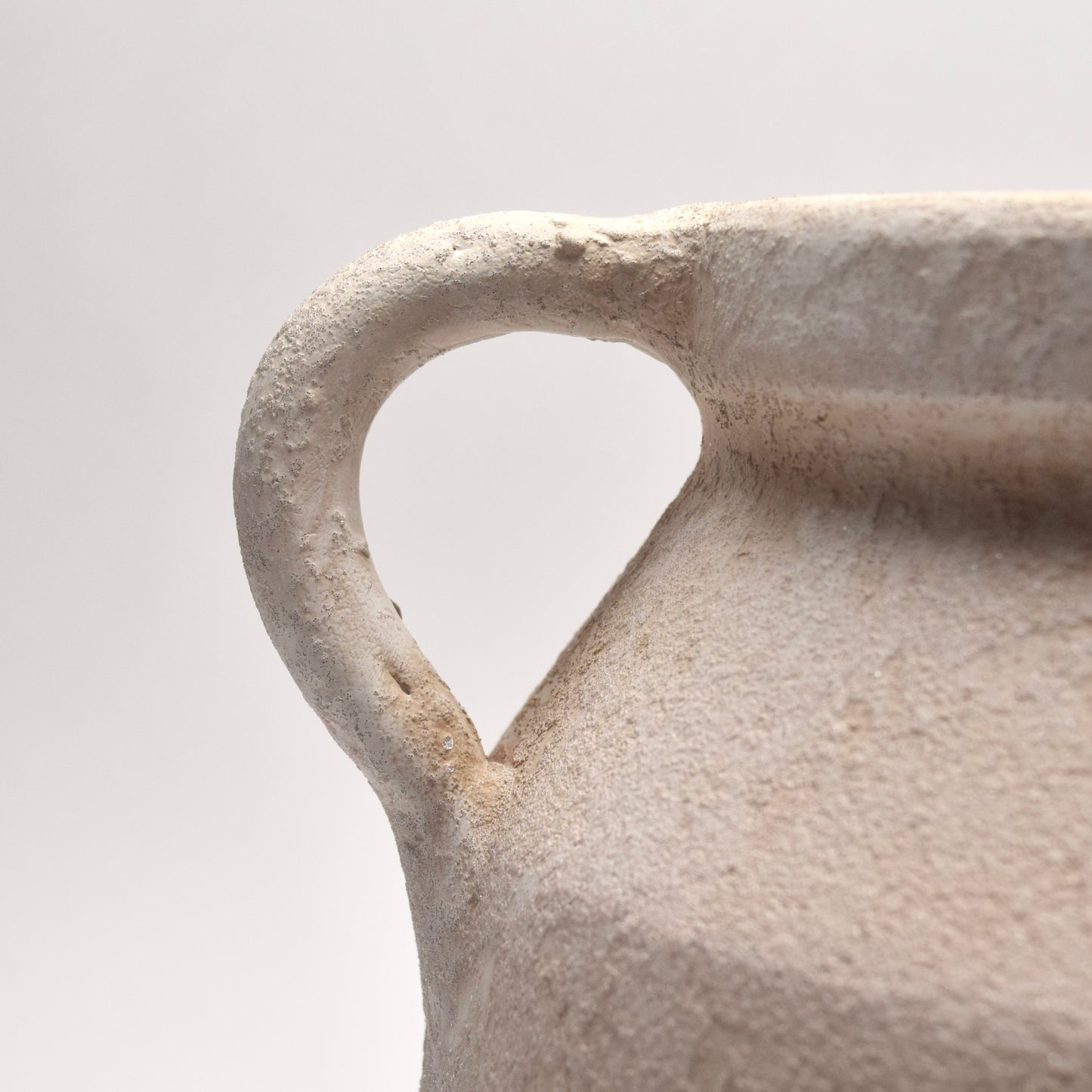 White ceramic vase closeup of its handle