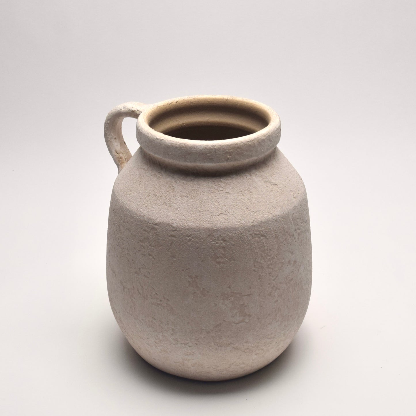 Off-white terracotta textured statement vase with a handle 
