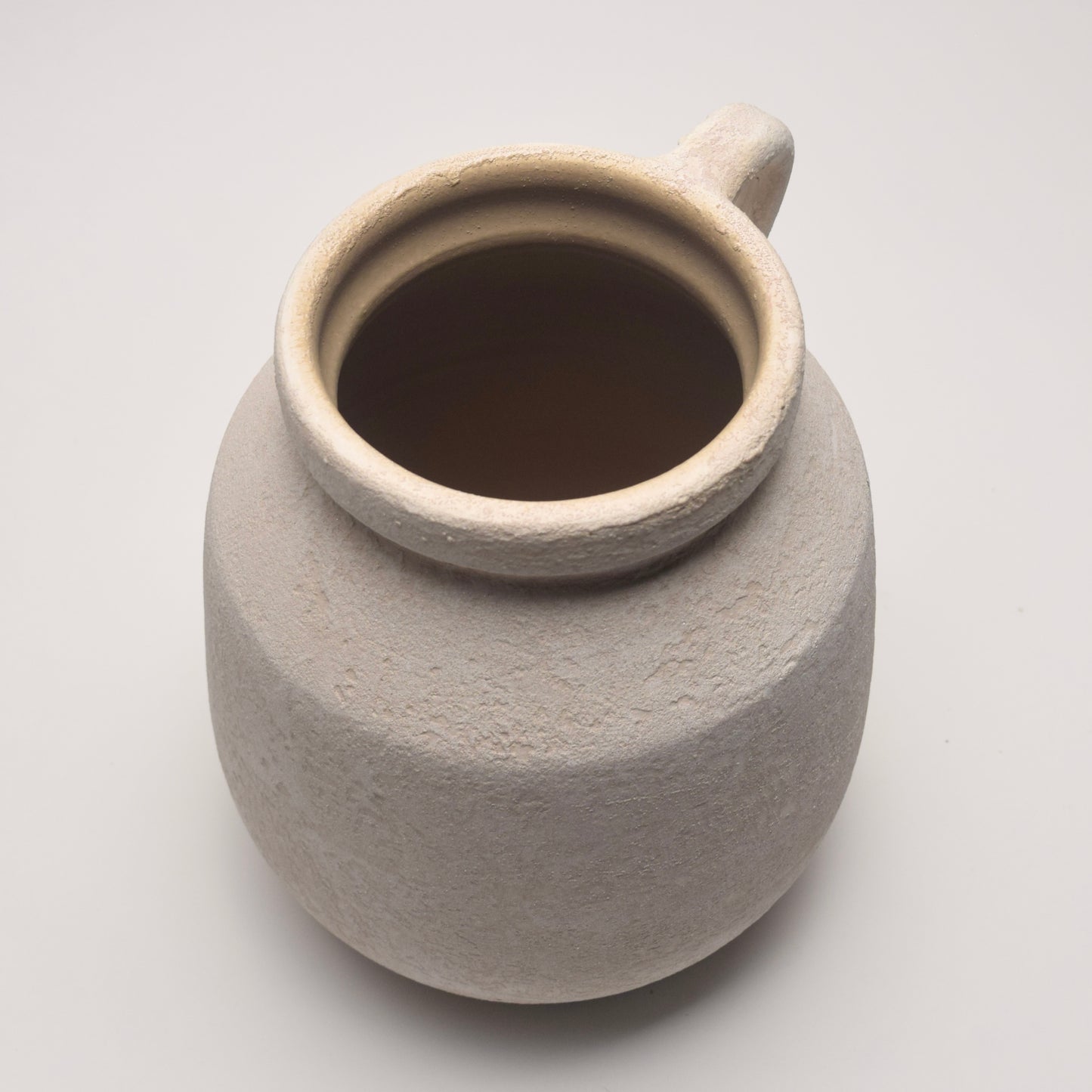 Off-white ceramic textured vase with elegant handle 