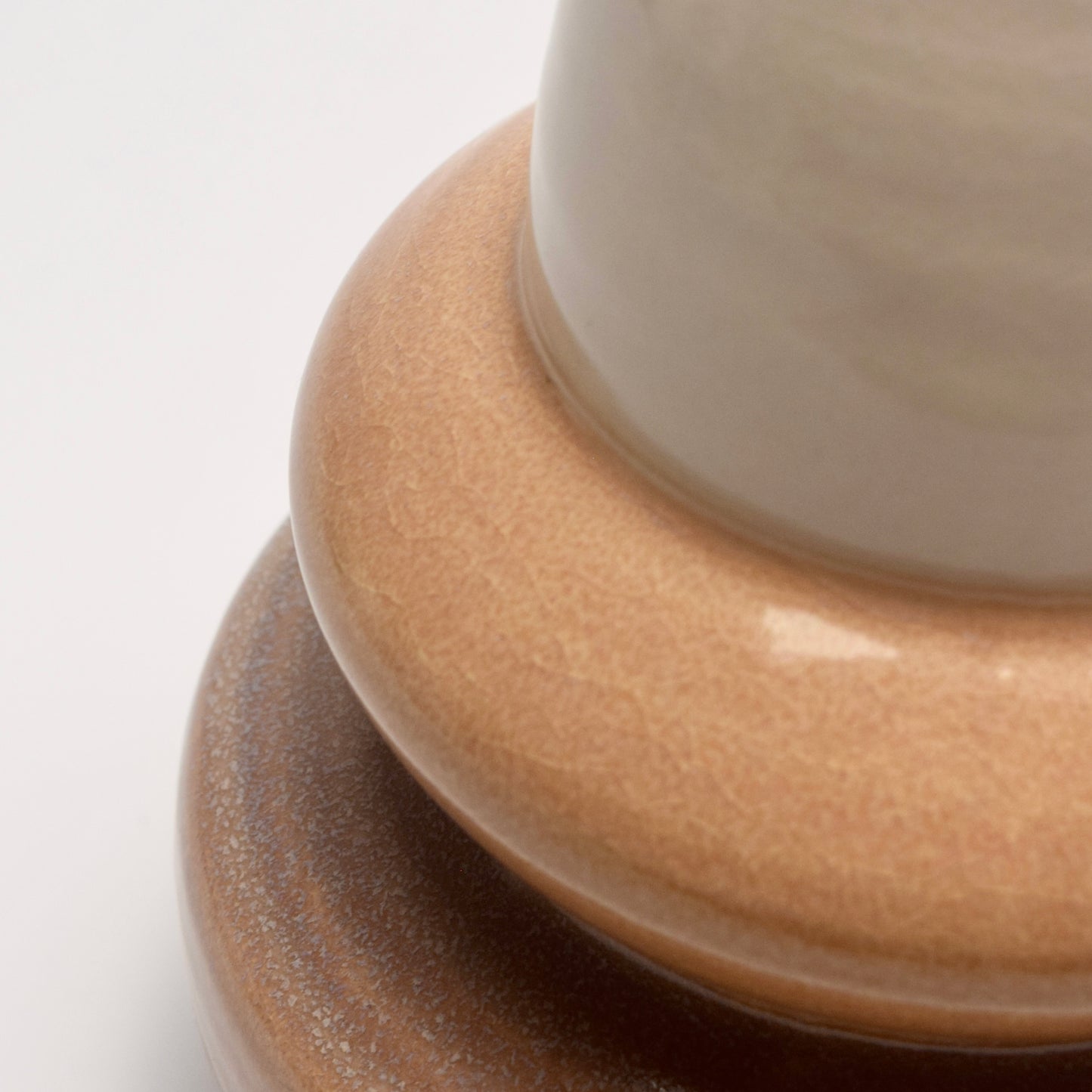 Close-up of sand toned vase with three distinct sections