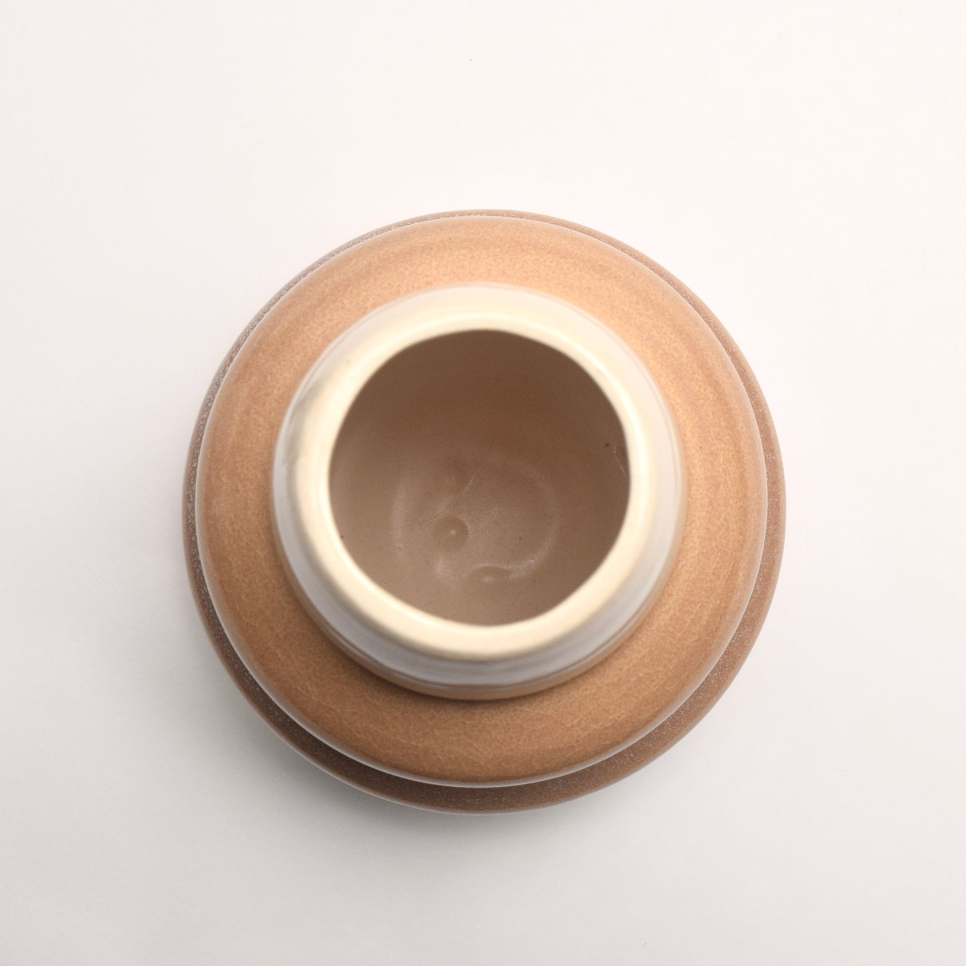 Top view of a neutral tan, cream and brown ombre vase 