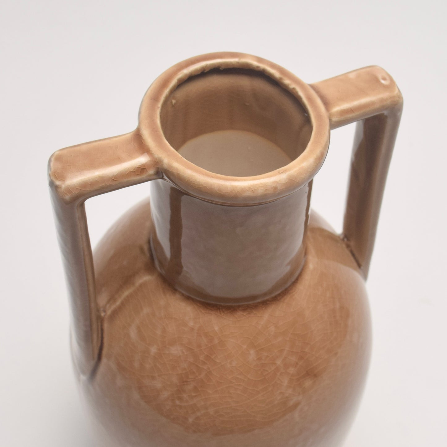 Brown ceramic vase with circular neck and two angular handles 
