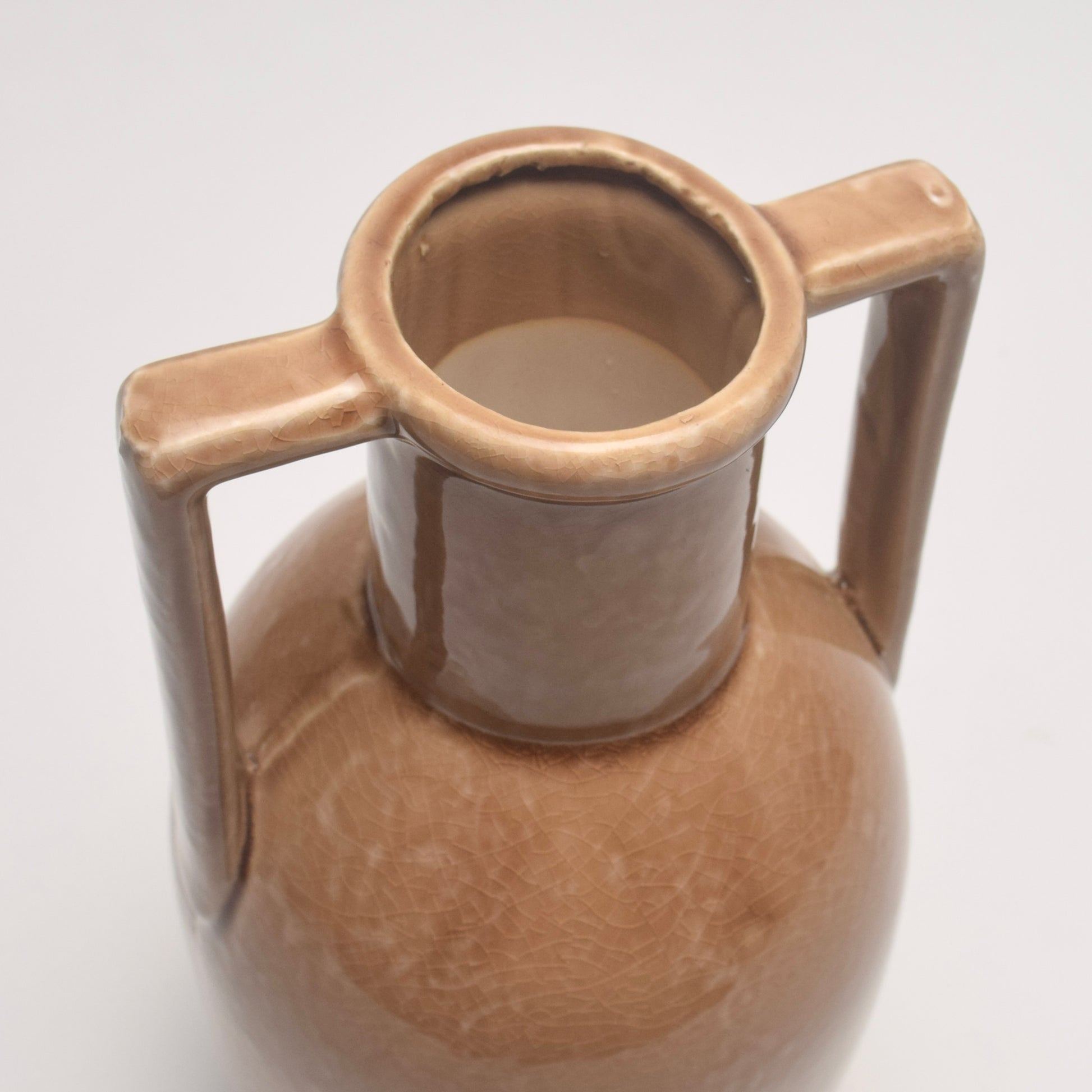 Brown ceramic vase with circular neck and two angular handles 