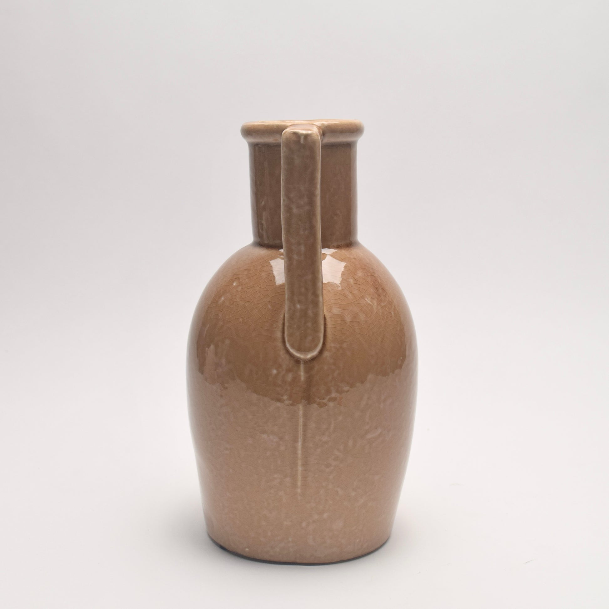Tan ceramic vase with rounded body and angular handles