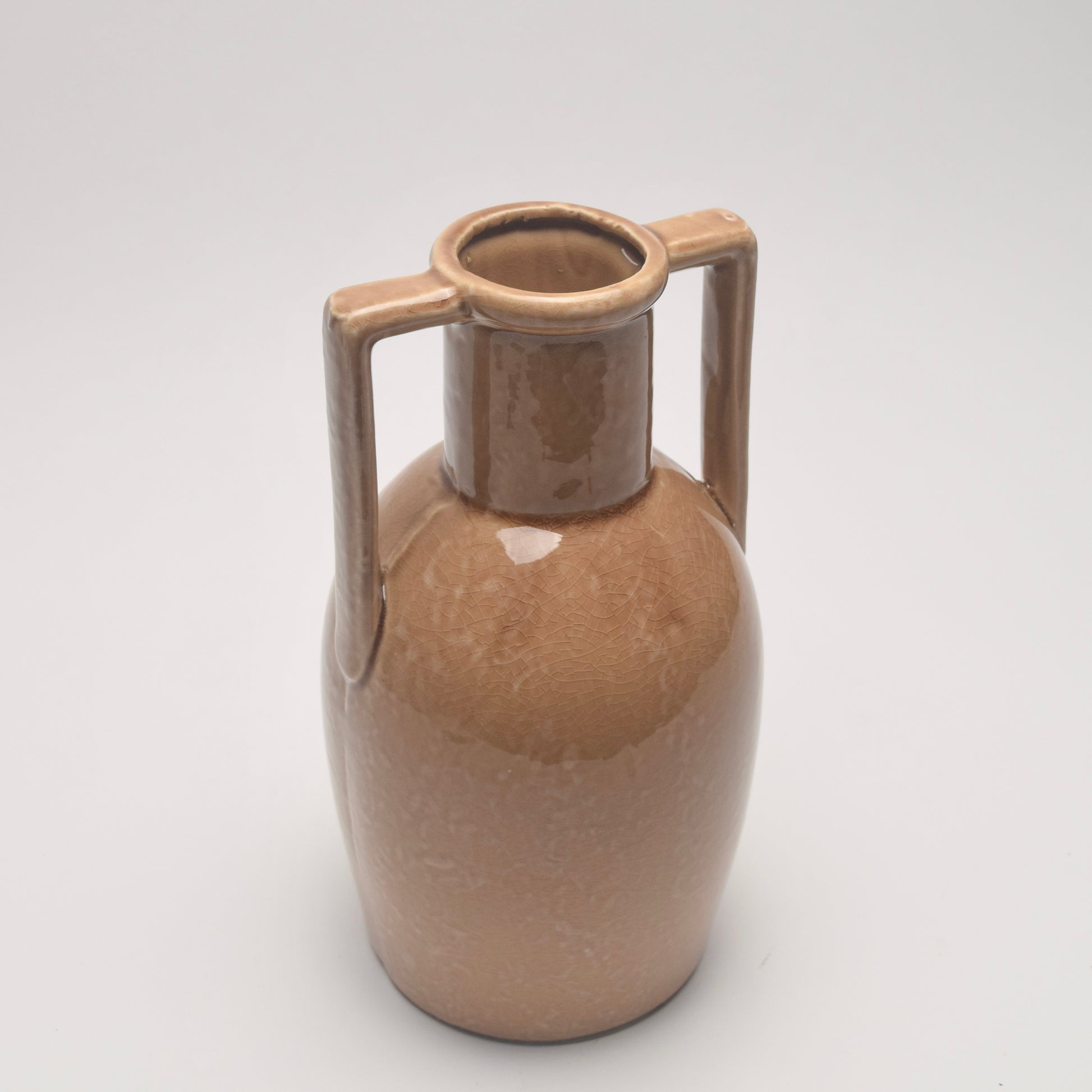 Brown ceramic jug with two statement handles. 