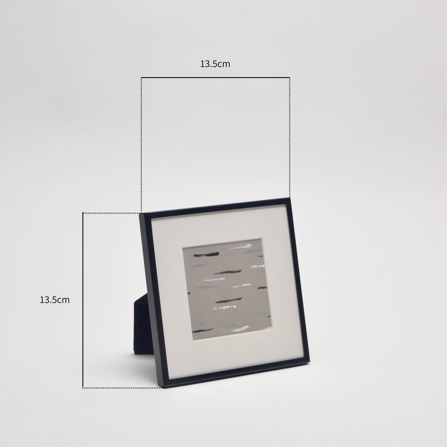 Framed taupe artwork in black frame with dimensions indicated on a light background.